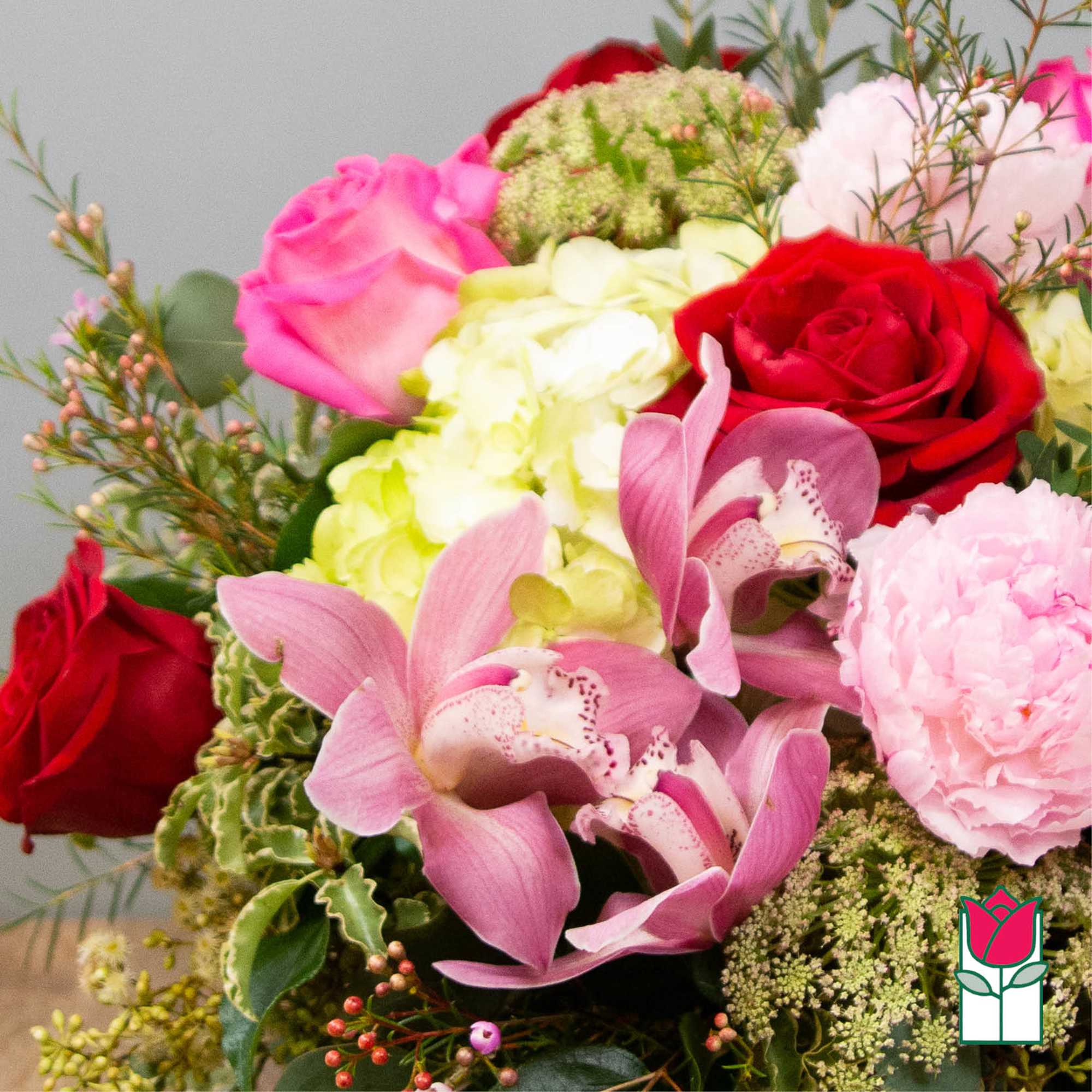 Bouquet of pink and red roses with orchids and hydrangea