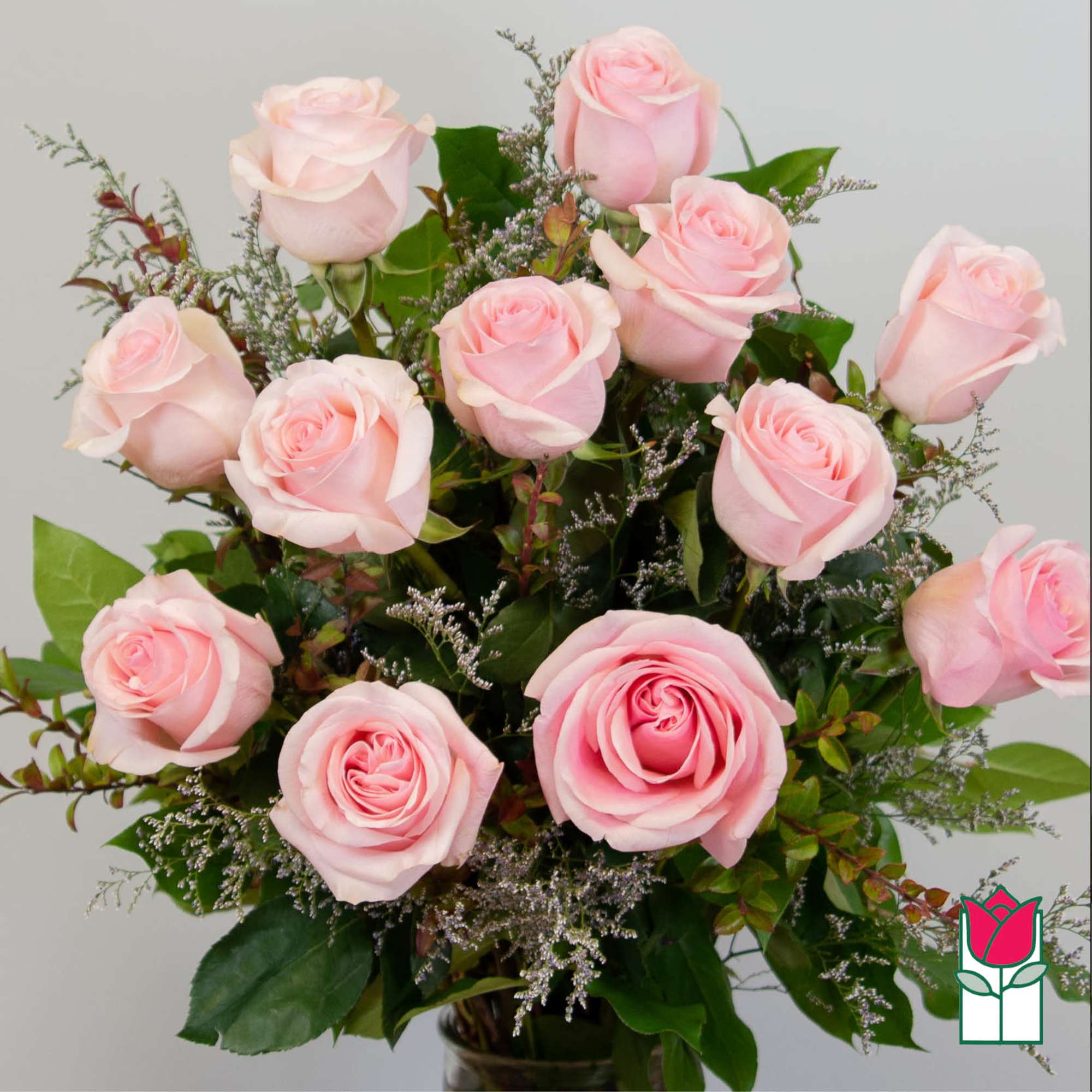 Bouquet of pale pink roses with greenery in a vase