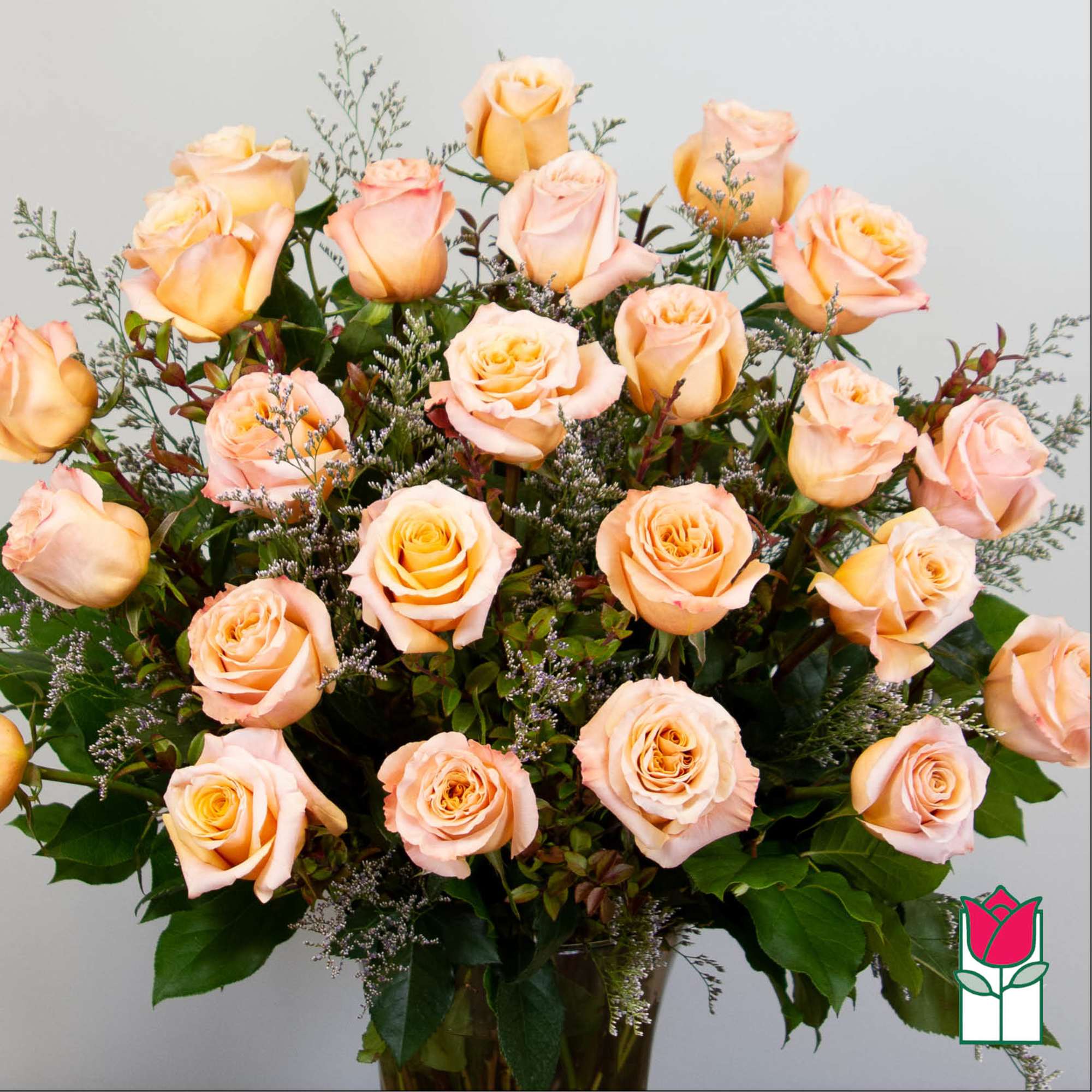 Bouquet of peach roses with greenery in a vase