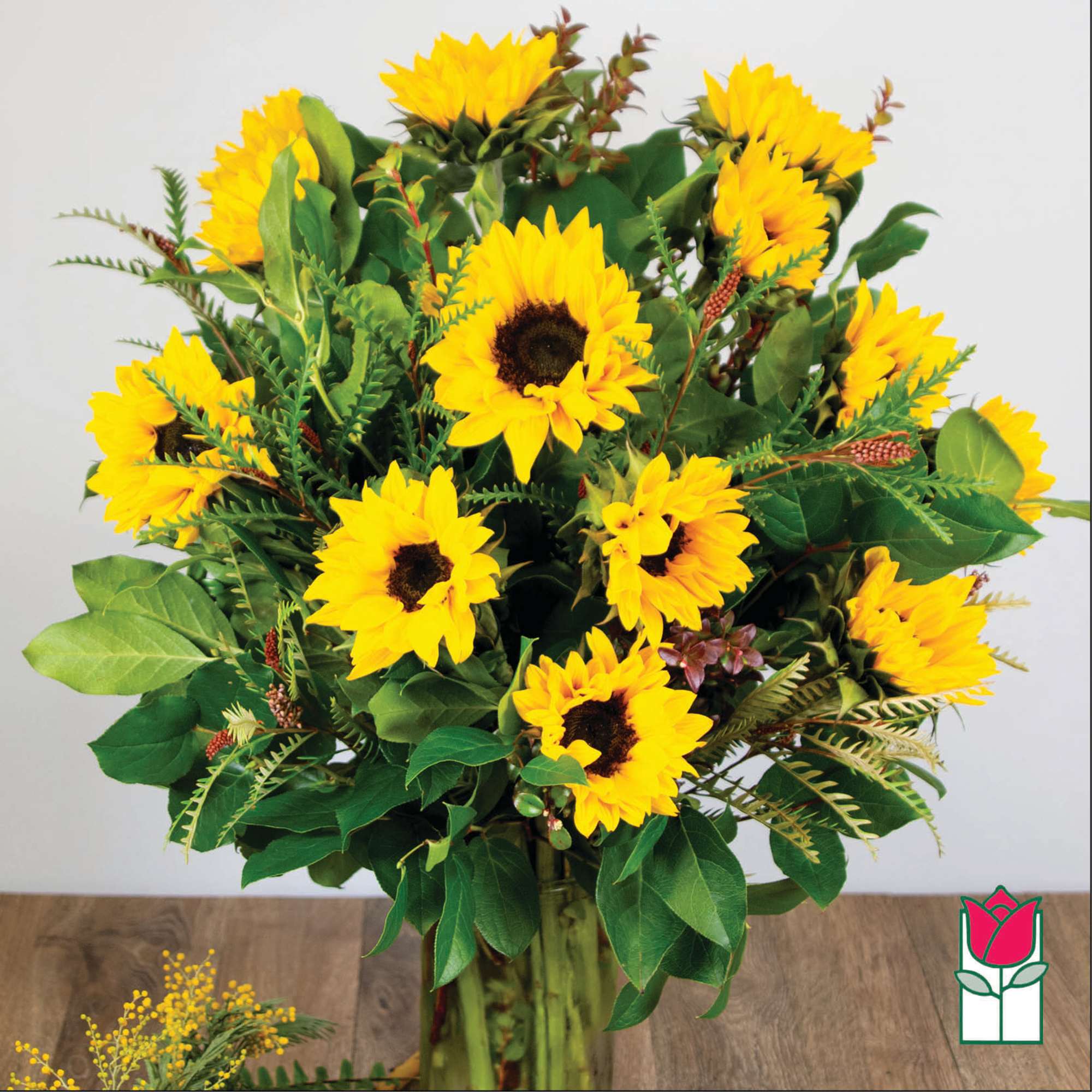Bouquet of yellow sunflowers in a clear glass vase
