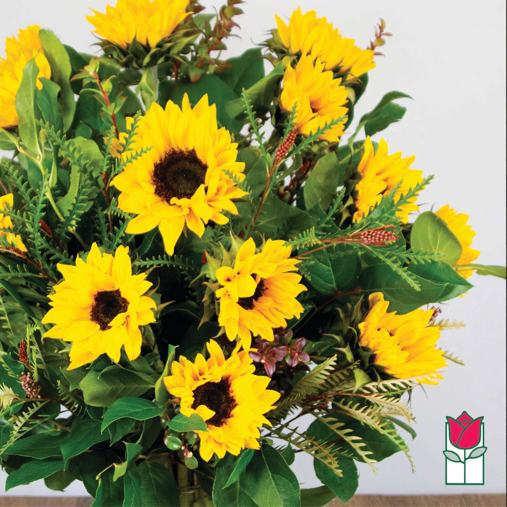 Bouquet of yellow sunflowers with mixed greenery