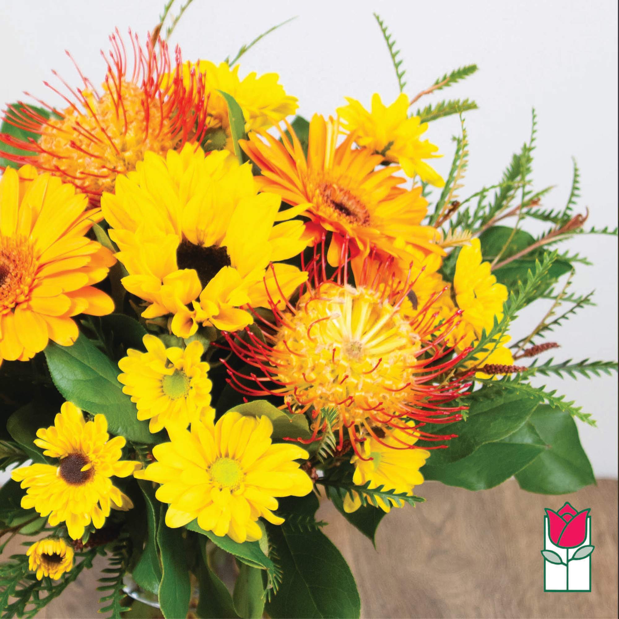 Yellow and orange mixed bouquet with daisy-like blooms and spiky flowers