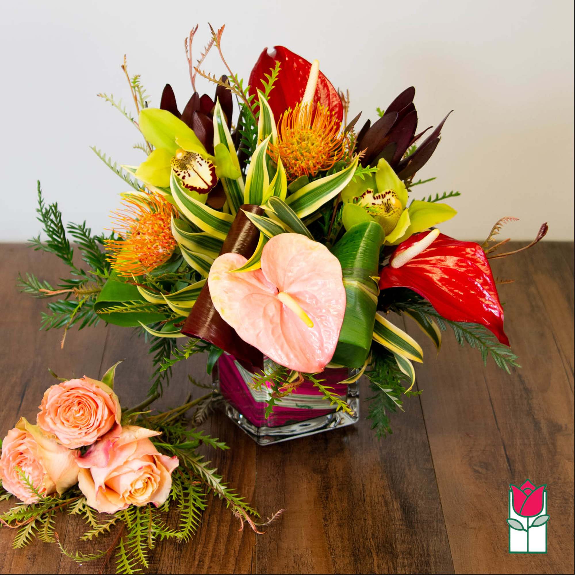 Tropical bouquet with anthuriums, orchids, and roses in a glass vase, photo 2 of 4