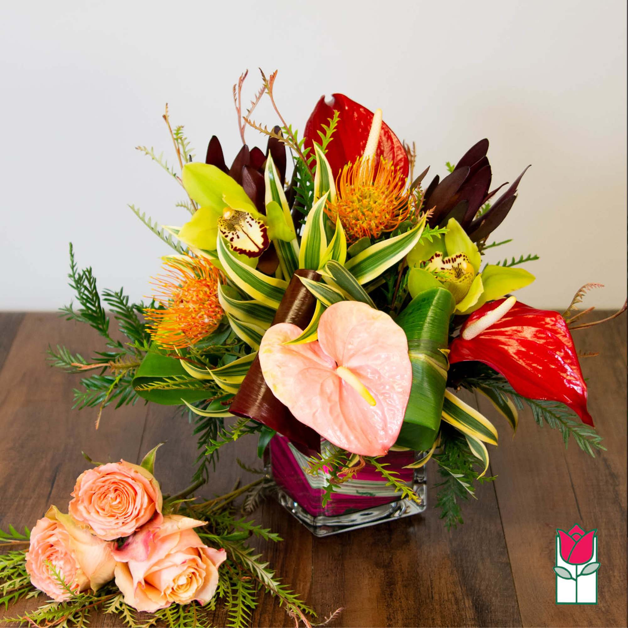 Tropical bouquet with anthuriums, orchids, and roses in a glass vase, photo 3 of 4