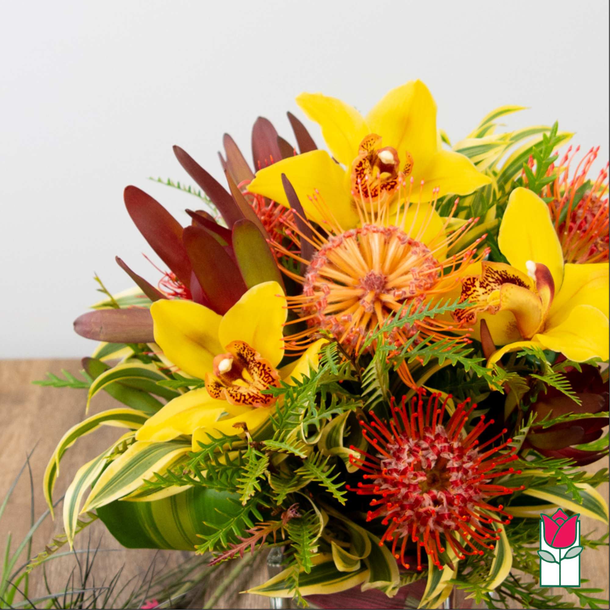 Bouquet with yellow orchids and red tropical flowers
