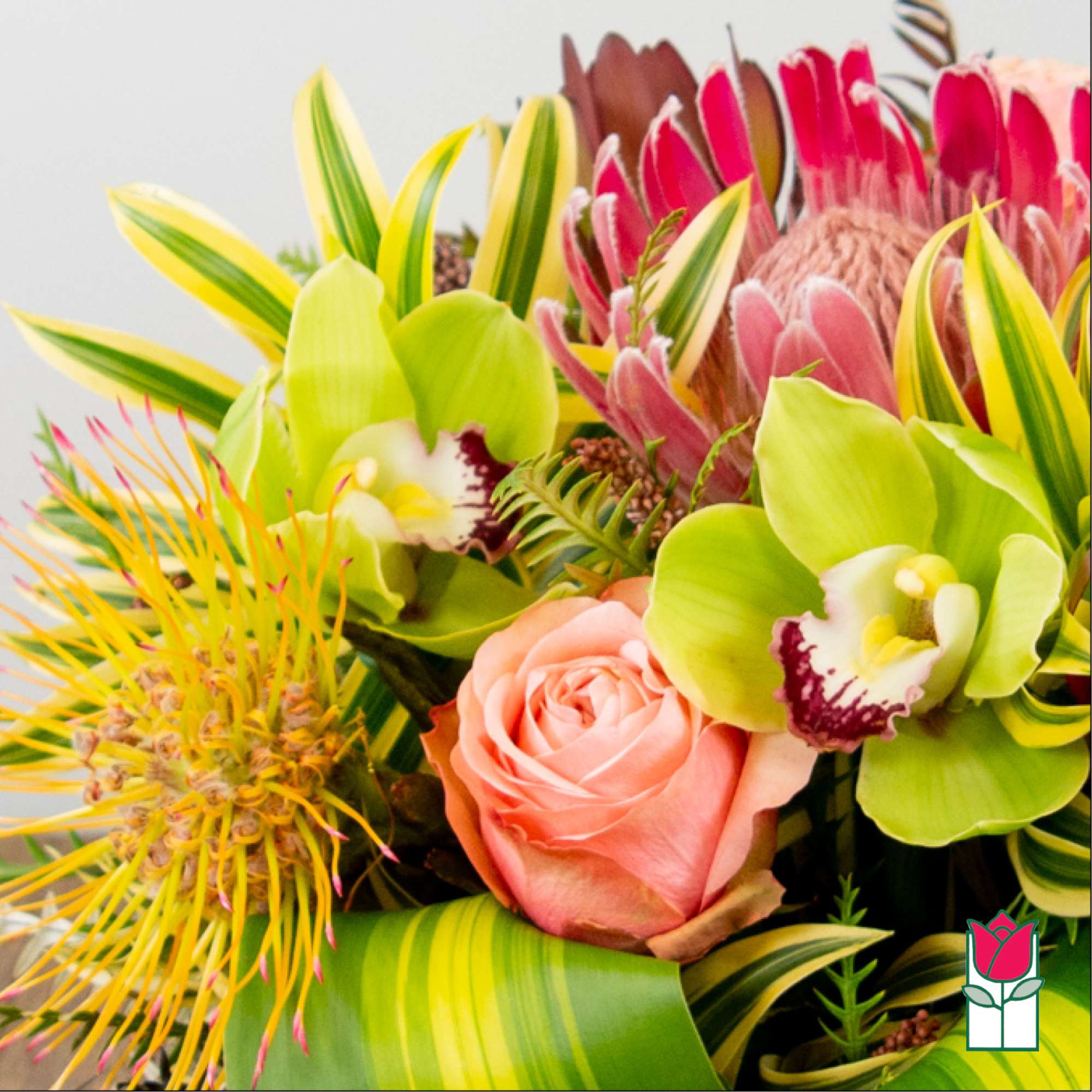 Tropical bouquet with pink roses and green orchids