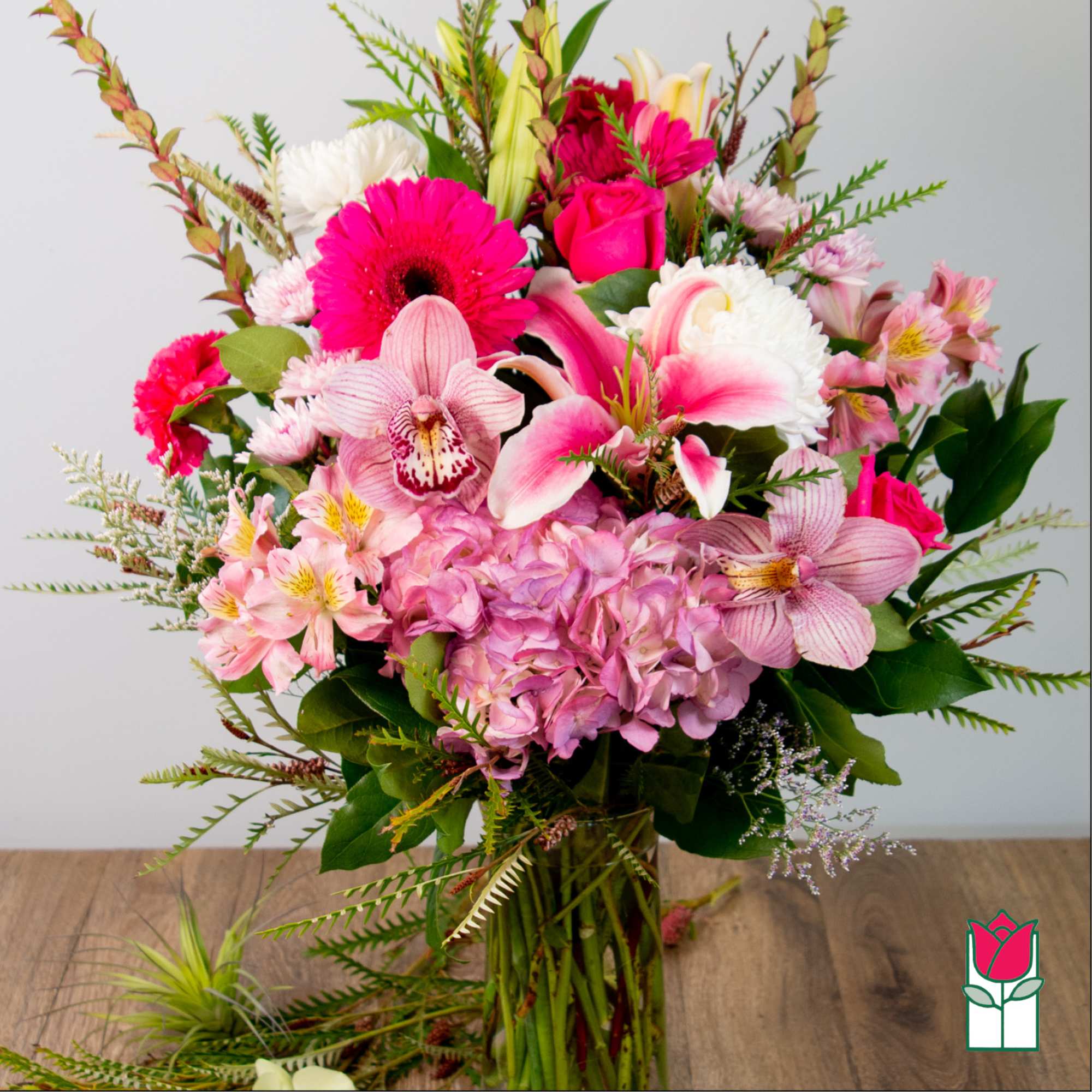 Pink and white mixed bouquet with orchids, roses, lilies, and hydrangea