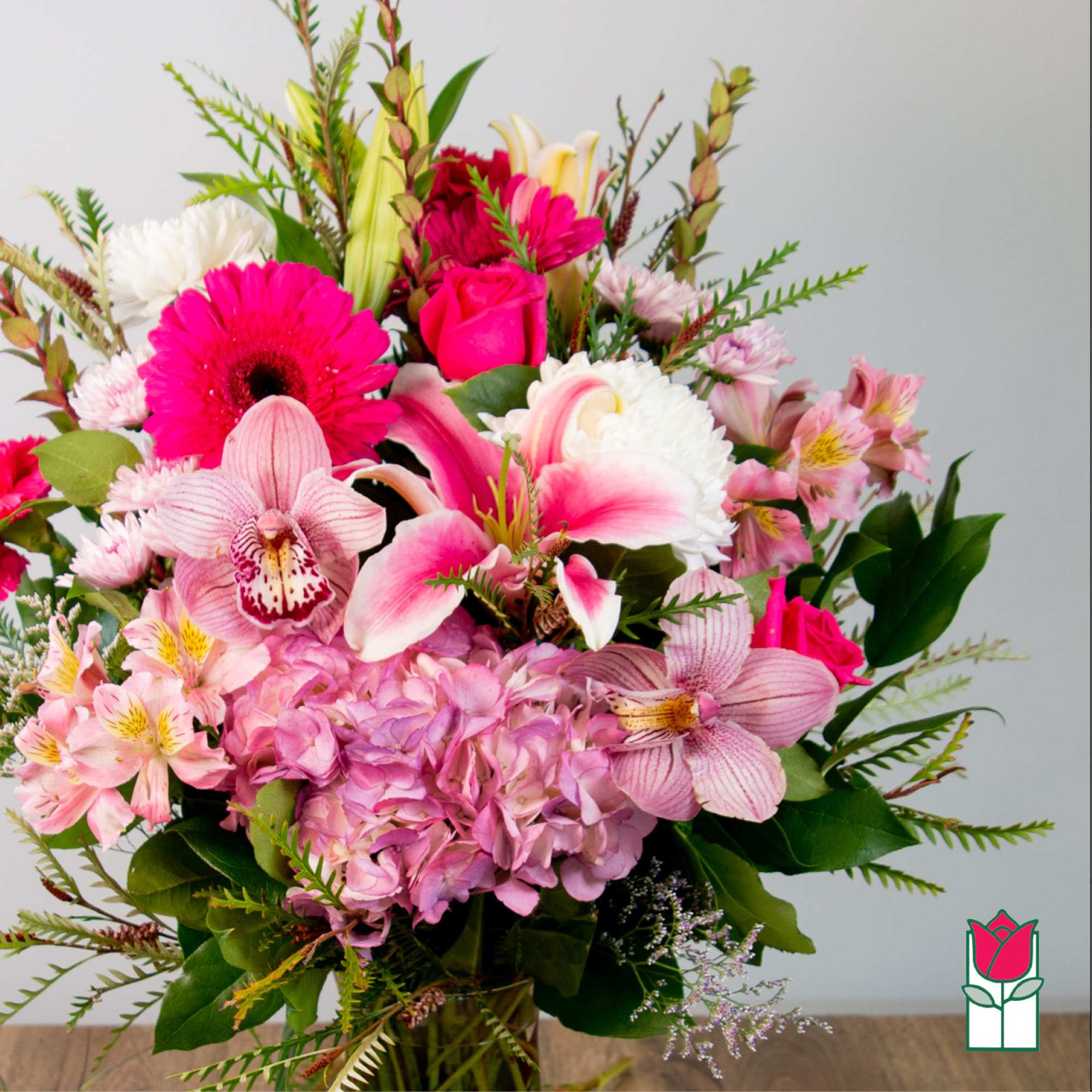 Bouquet of pink and white flowers with orchids, roses, and hydrangea