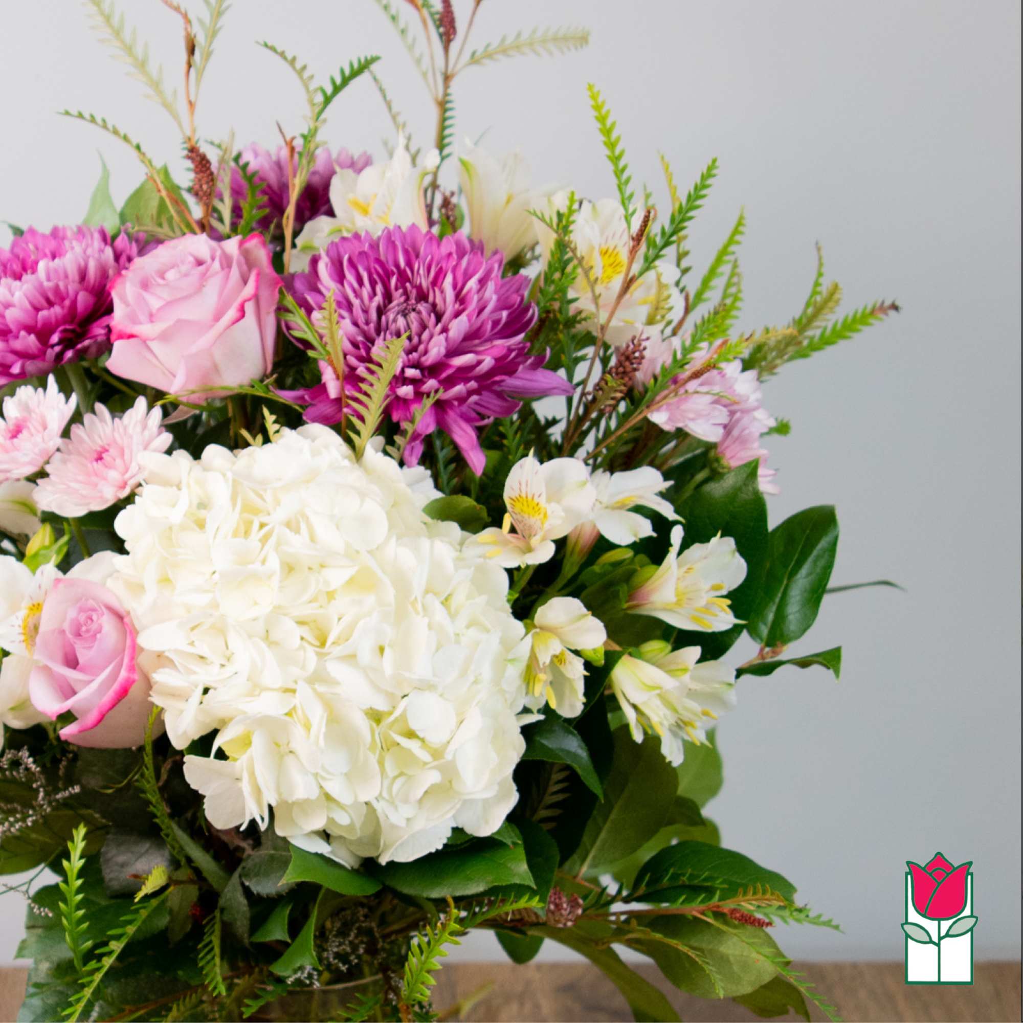 Bouquet of pink and white flowers with a large white hydrangea cluster