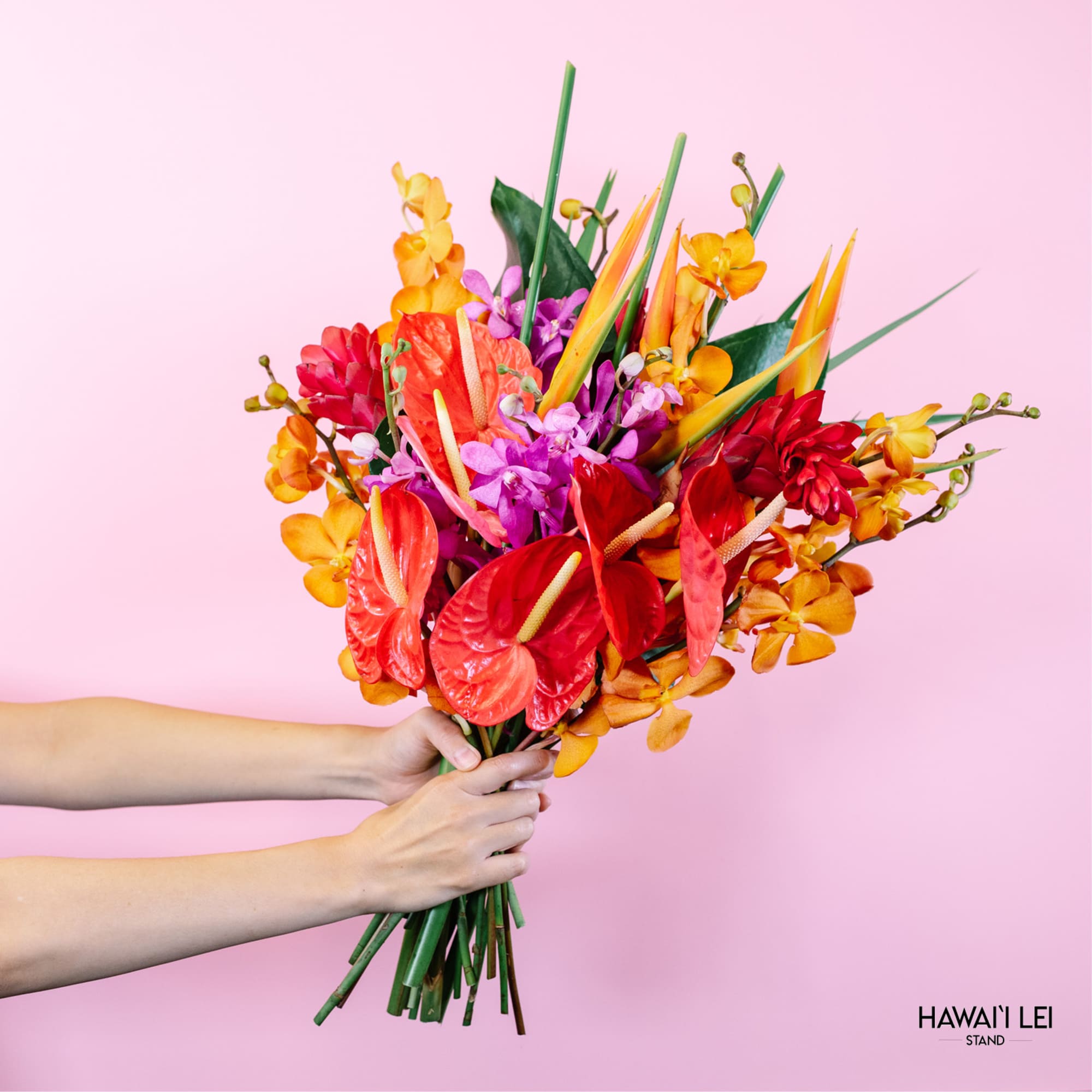 Tropical bouquet with red anthuriums and orange orchids