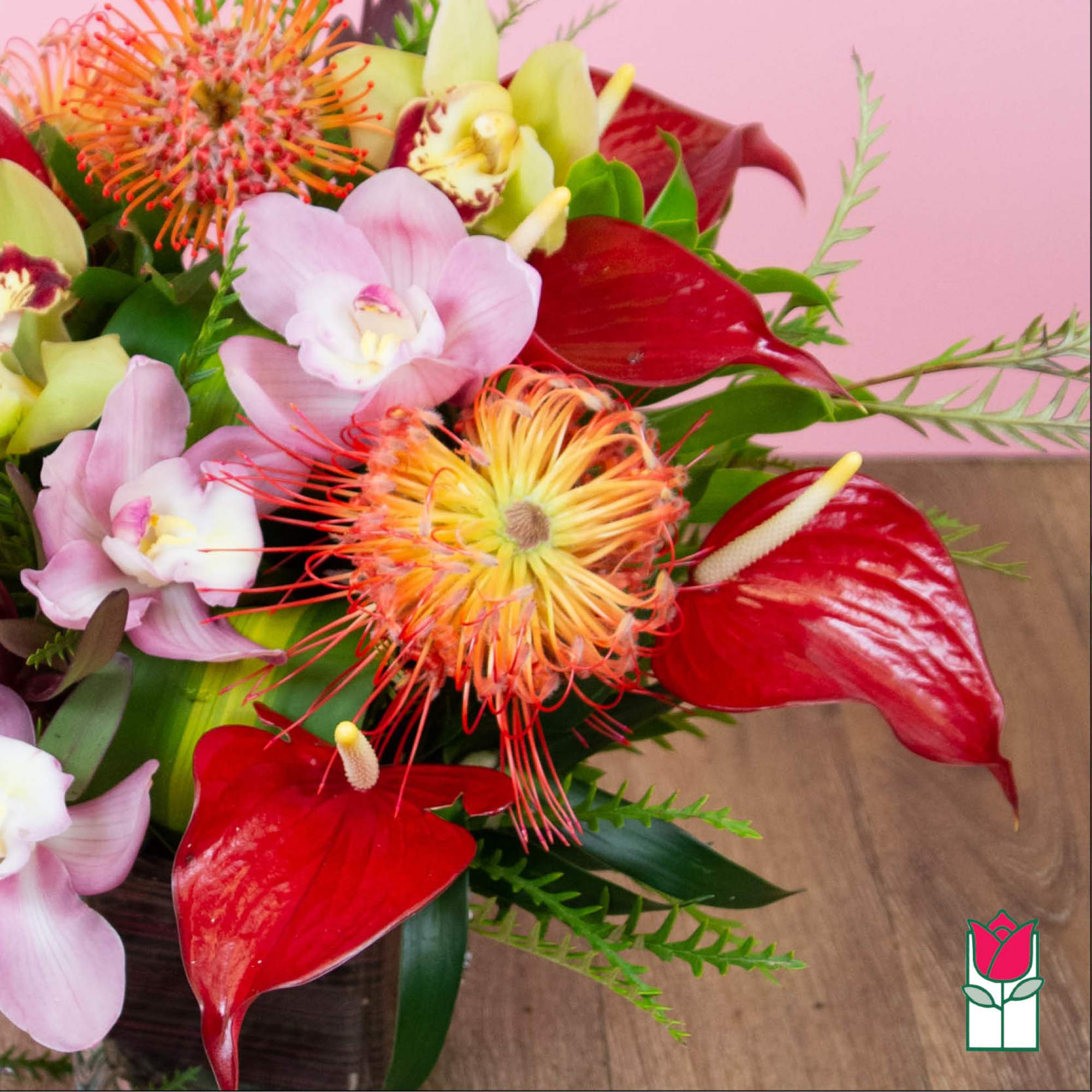 Bouquet with red anthuriums, pink orchids, and orange pincushion blooms