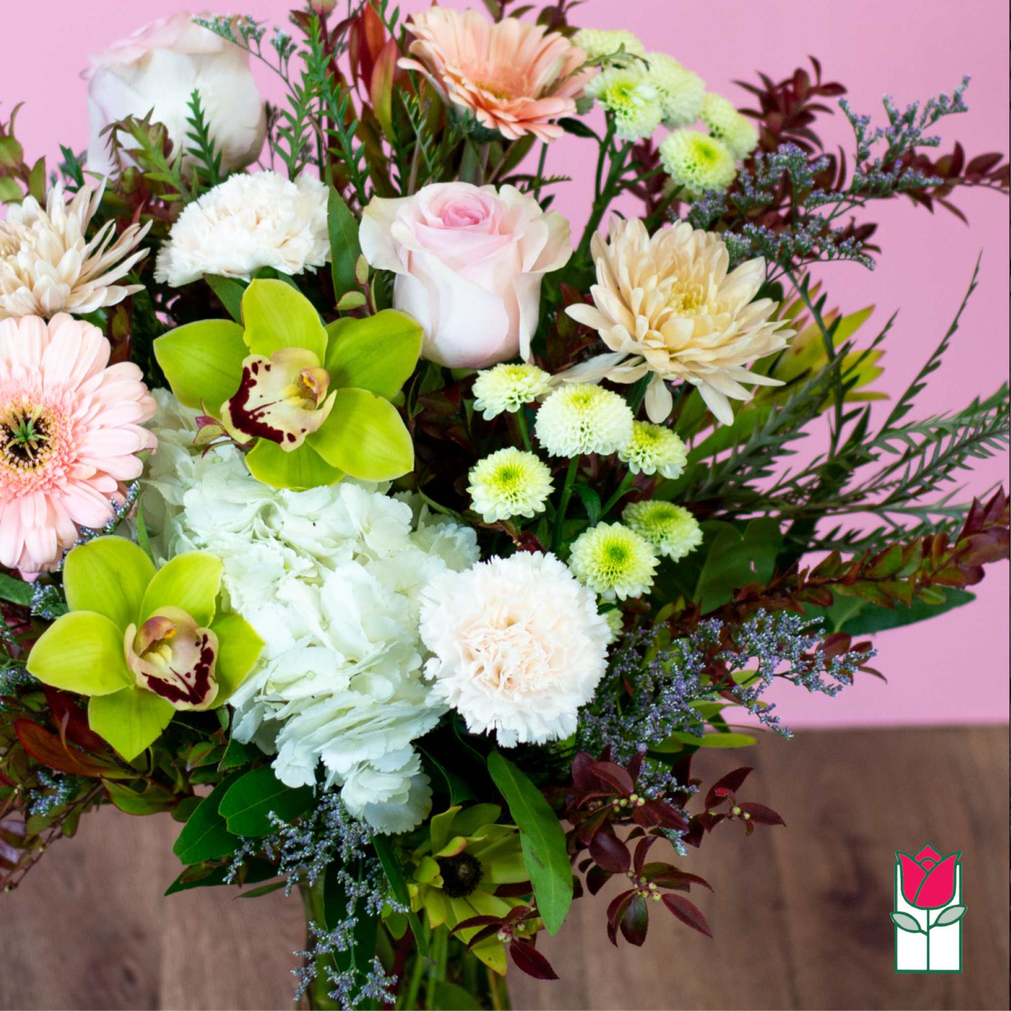 Bouquet of pink and white flowers with green orchids