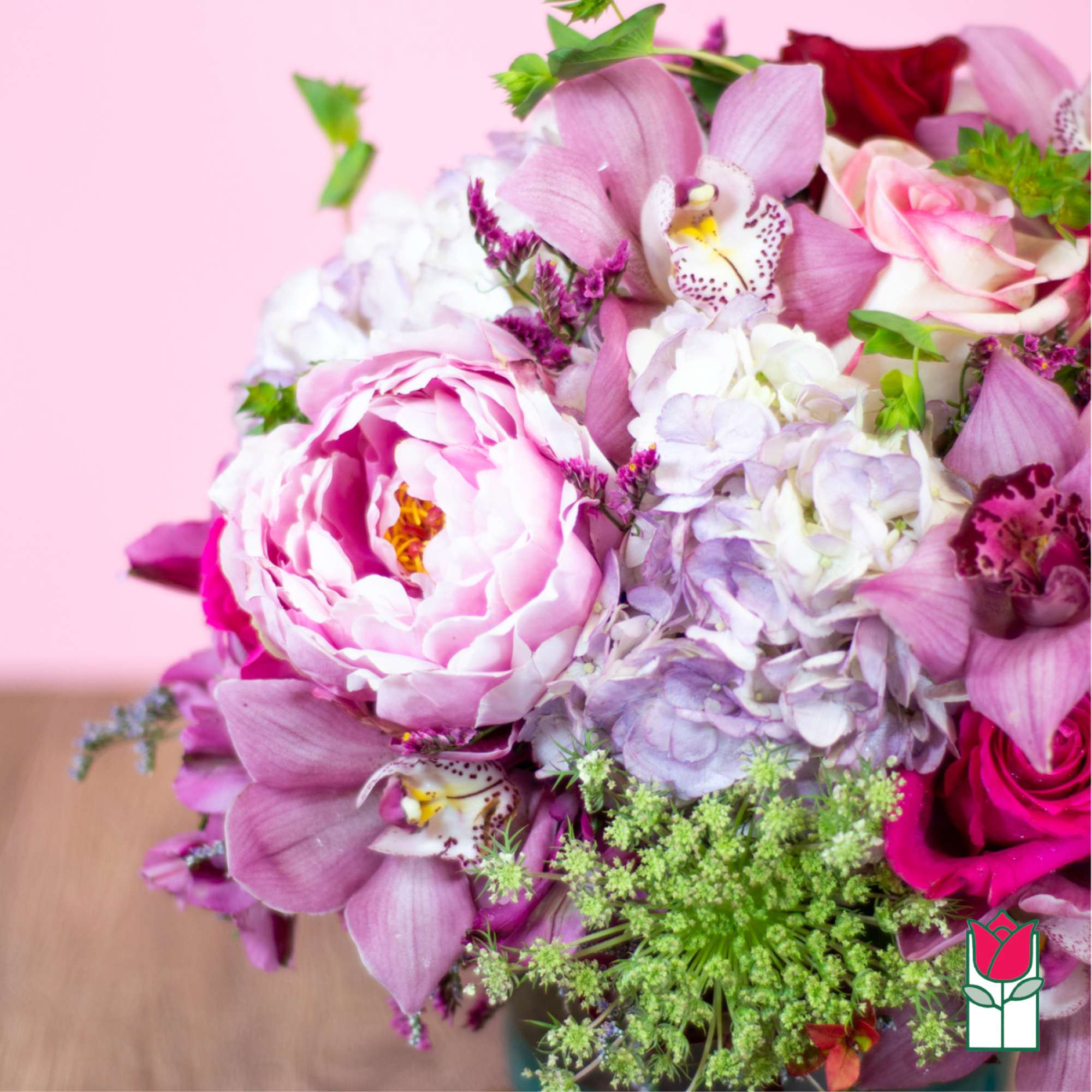 Pink and white bouquet with peonies, orchids, roses, and hydrangea