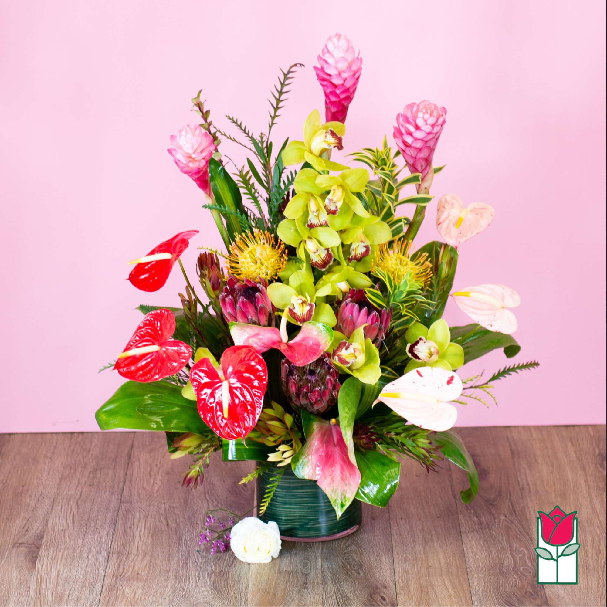 Tropical flower arrangement with orchids and anthuriums in a vase