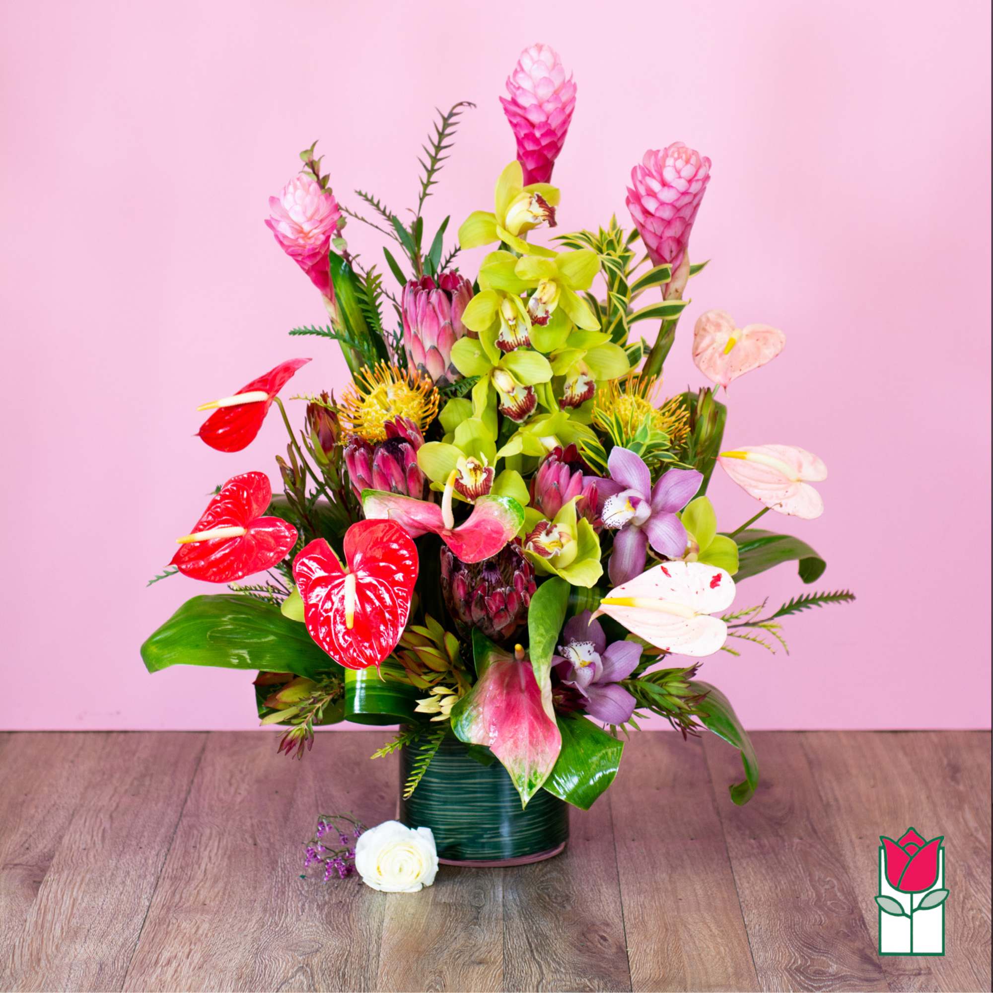 Tropical bouquet with pink and green flowers in a dark vase