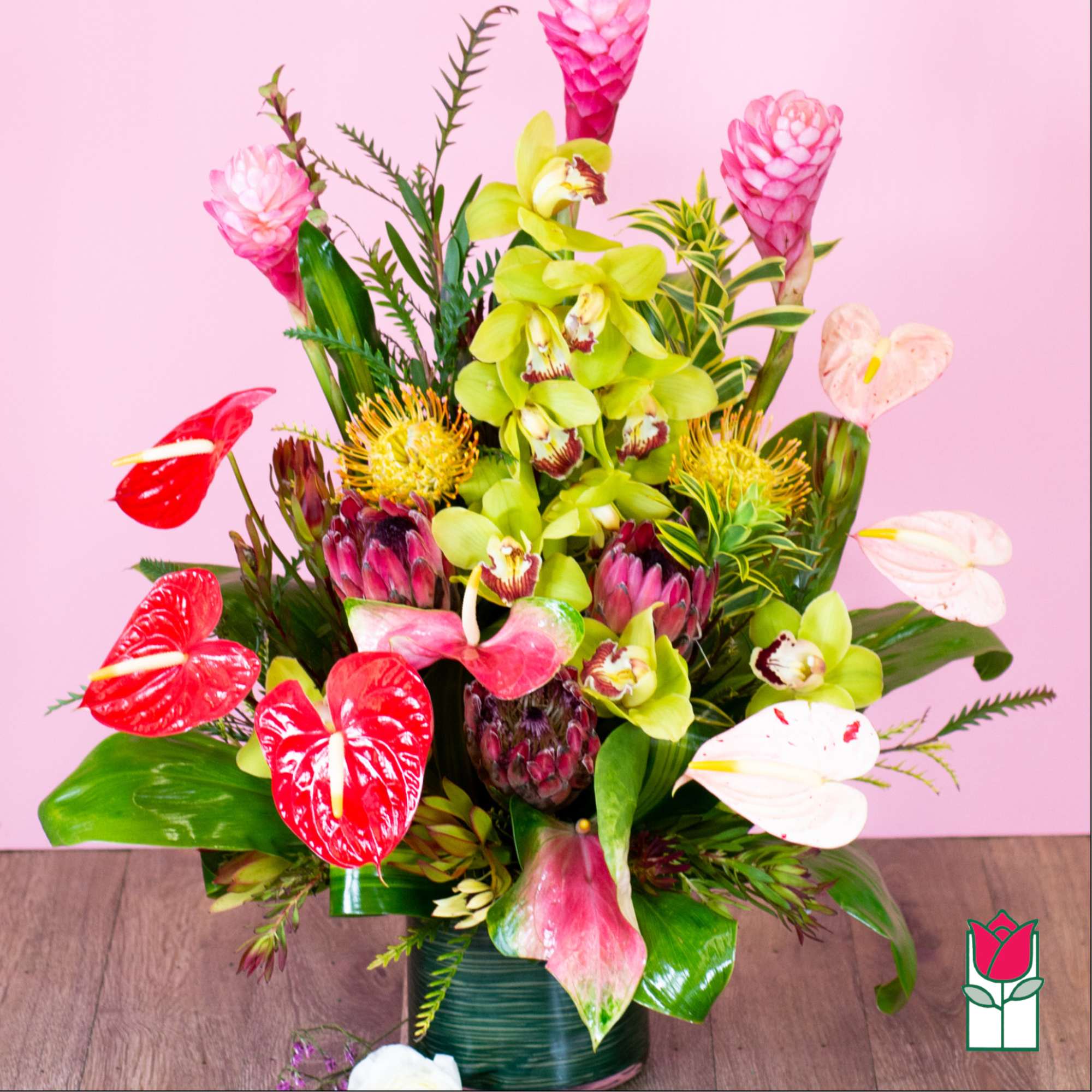 Tropical flower arrangement with orchids and anthuriums in a vase, photo 2 of 5