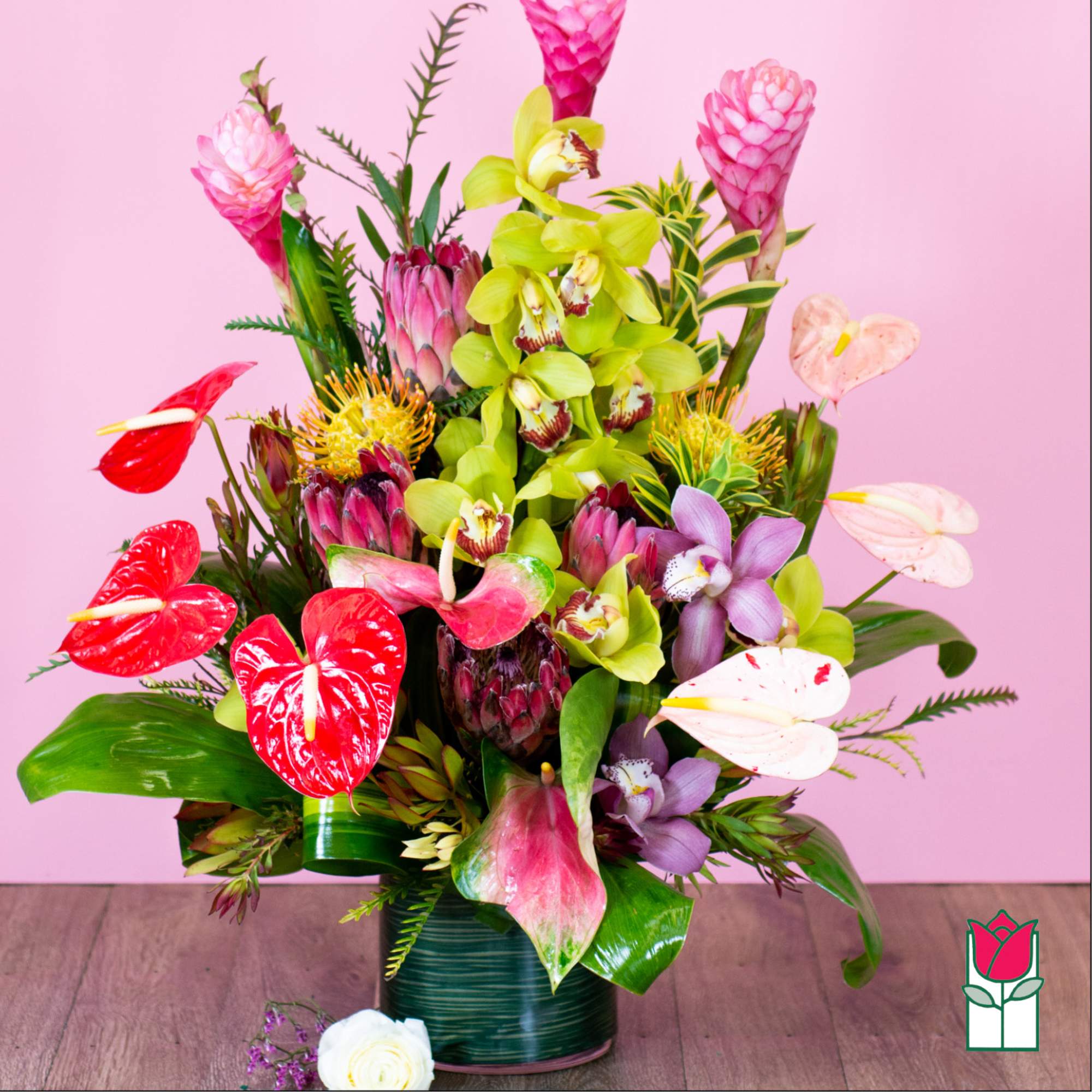 Tropical bouquet with orchids, anthuriums, and protea in a vase