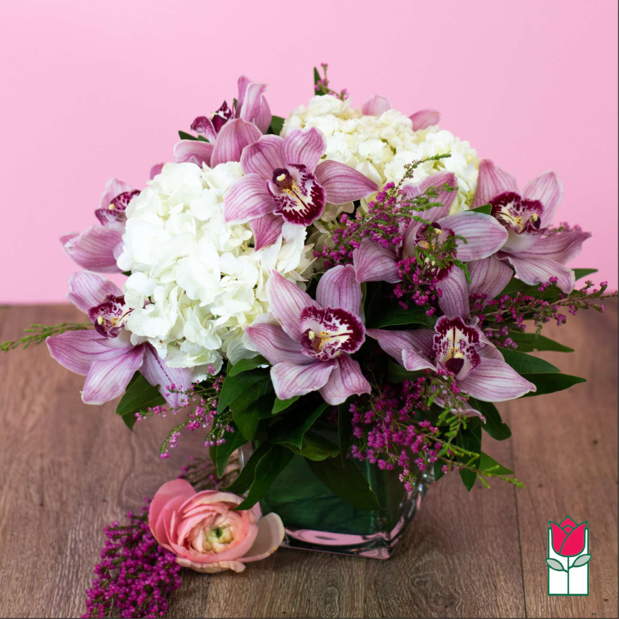 Pink orchids and white hydrangeas in a glass vase