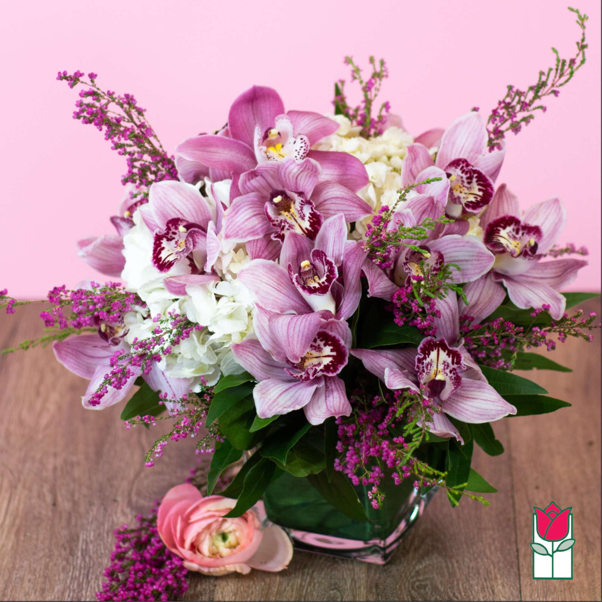 Pink orchids and white hydrangeas in a glass vase, photo 2 of 5