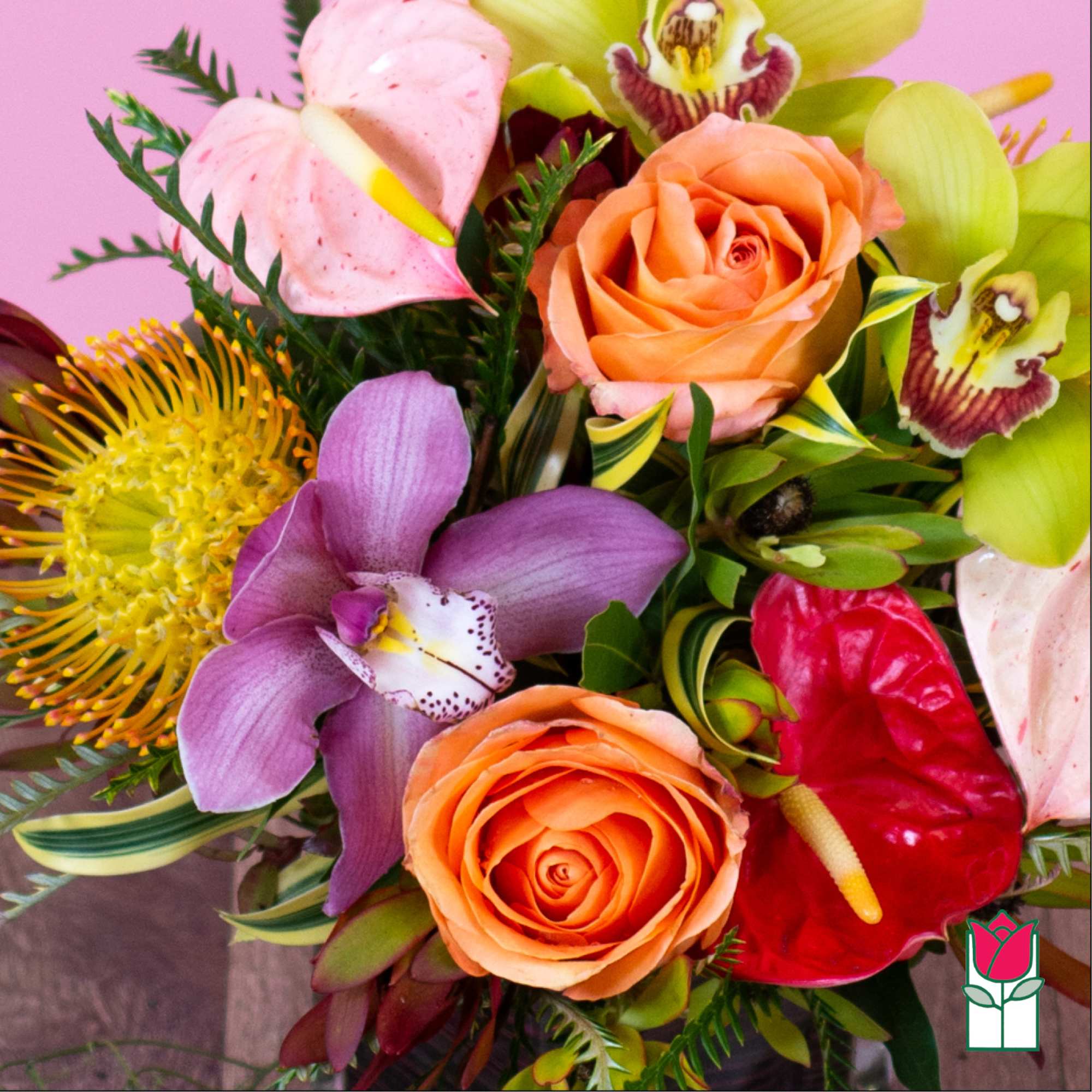 Colorful bouquet with orange roses, orchids, and anthuriums