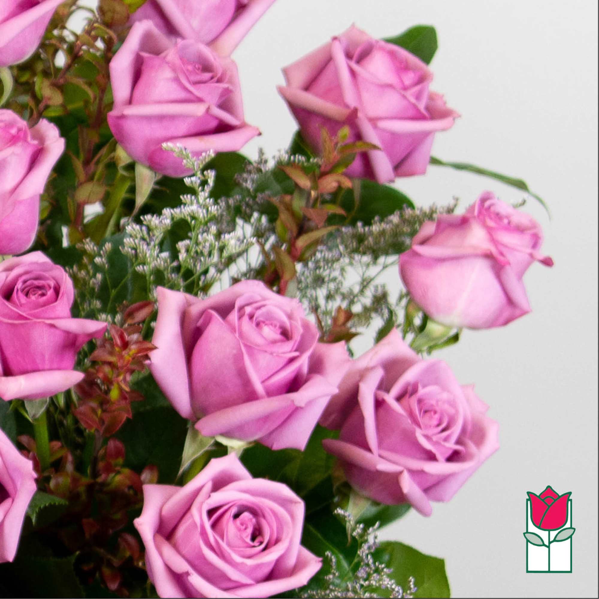 Bouquet of pink roses with mixed greenery on a white background