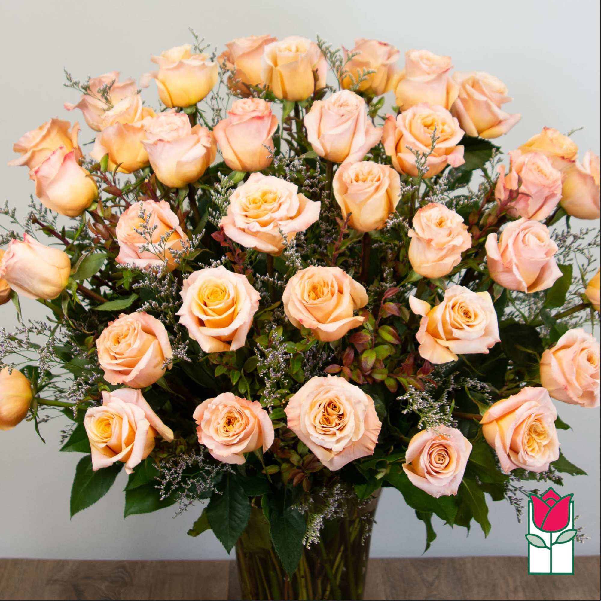 Peach roses arranged in a glass vase