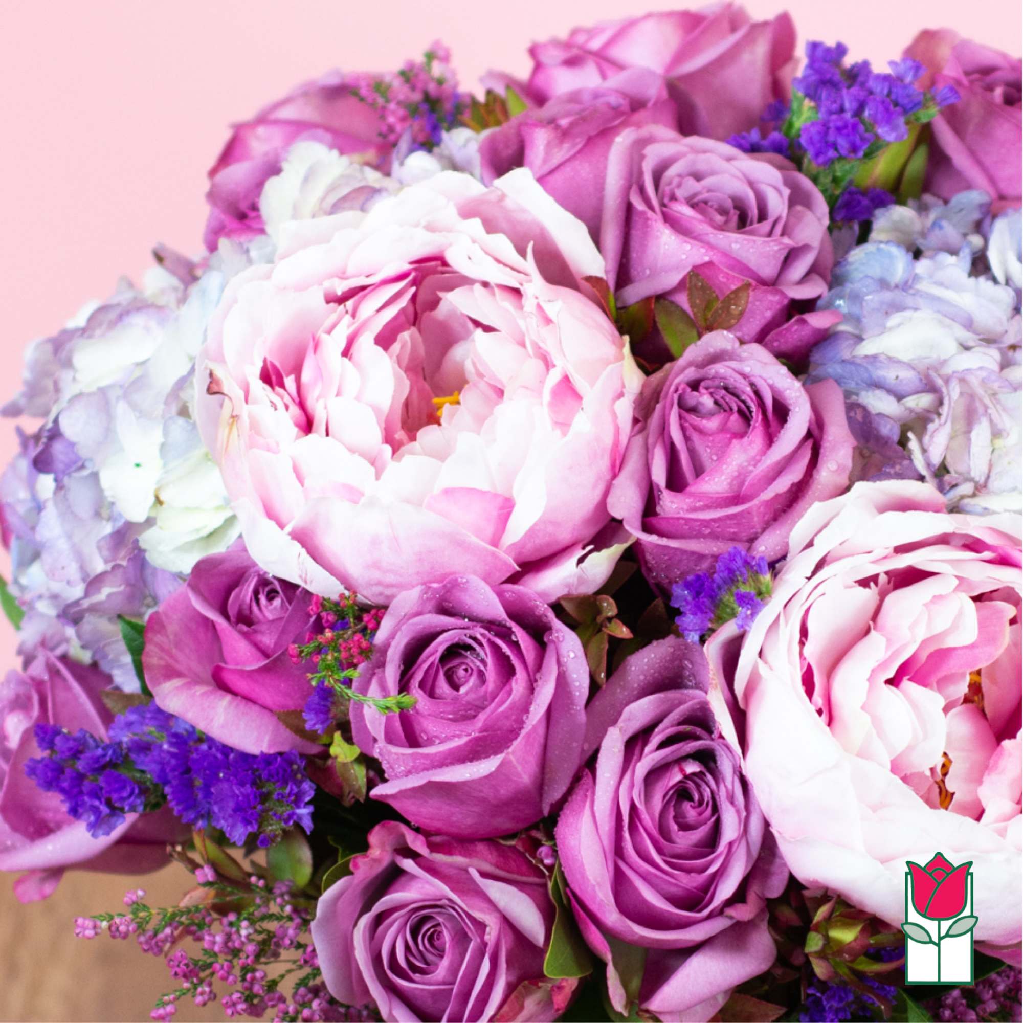 Bouquet of pink and lavender roses with pale peonies