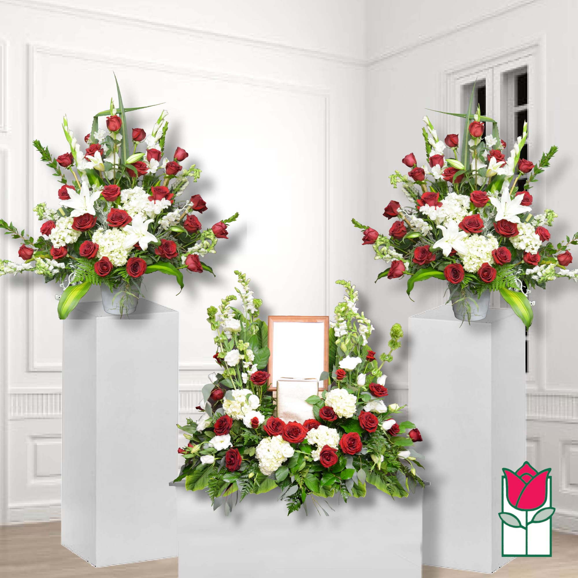 Symmetrical funeral floral display with red roses and white lilies