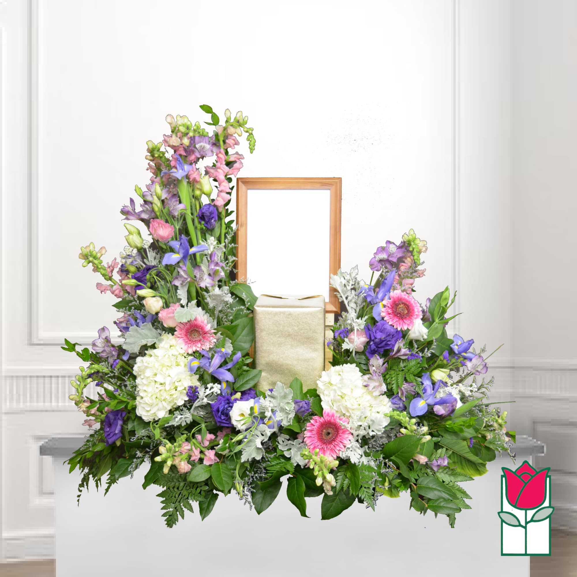 Symmetrical floral funeral arrangement with pink, purple, and white blooms