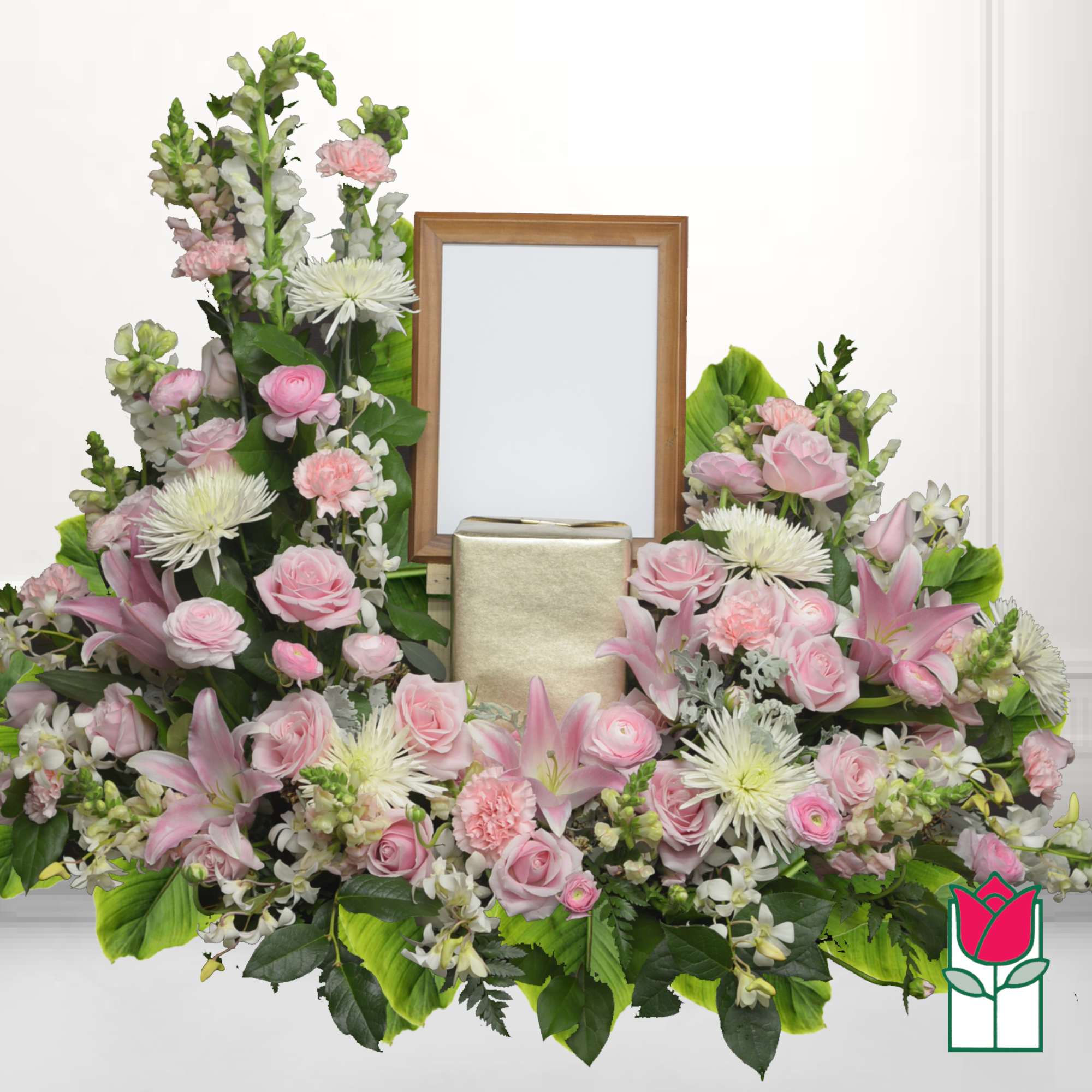 Pink and white floral funeral arrangement with a framed photo holder