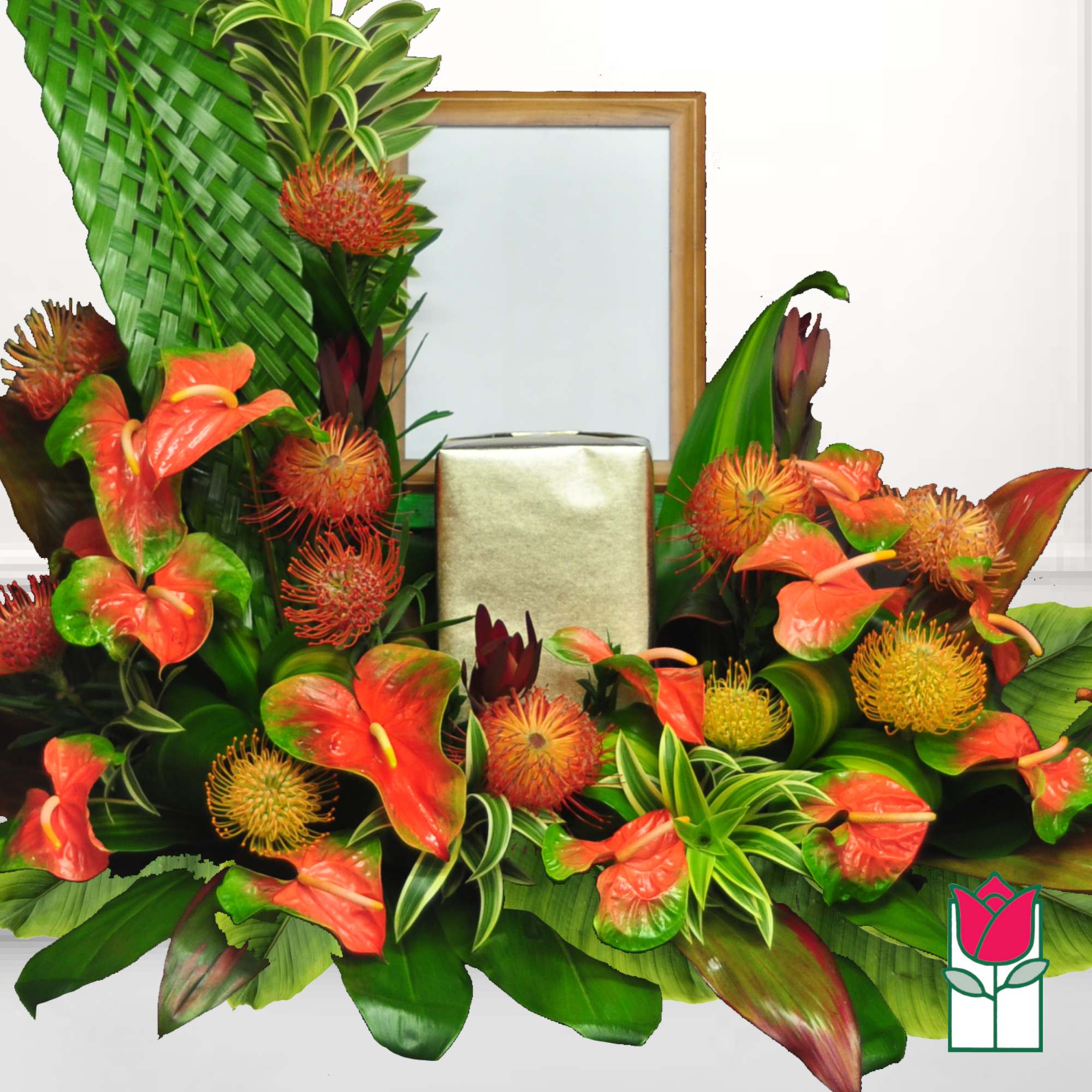 Tropical floral arrangement with orange anthuriums and spiky blooms around a gold box