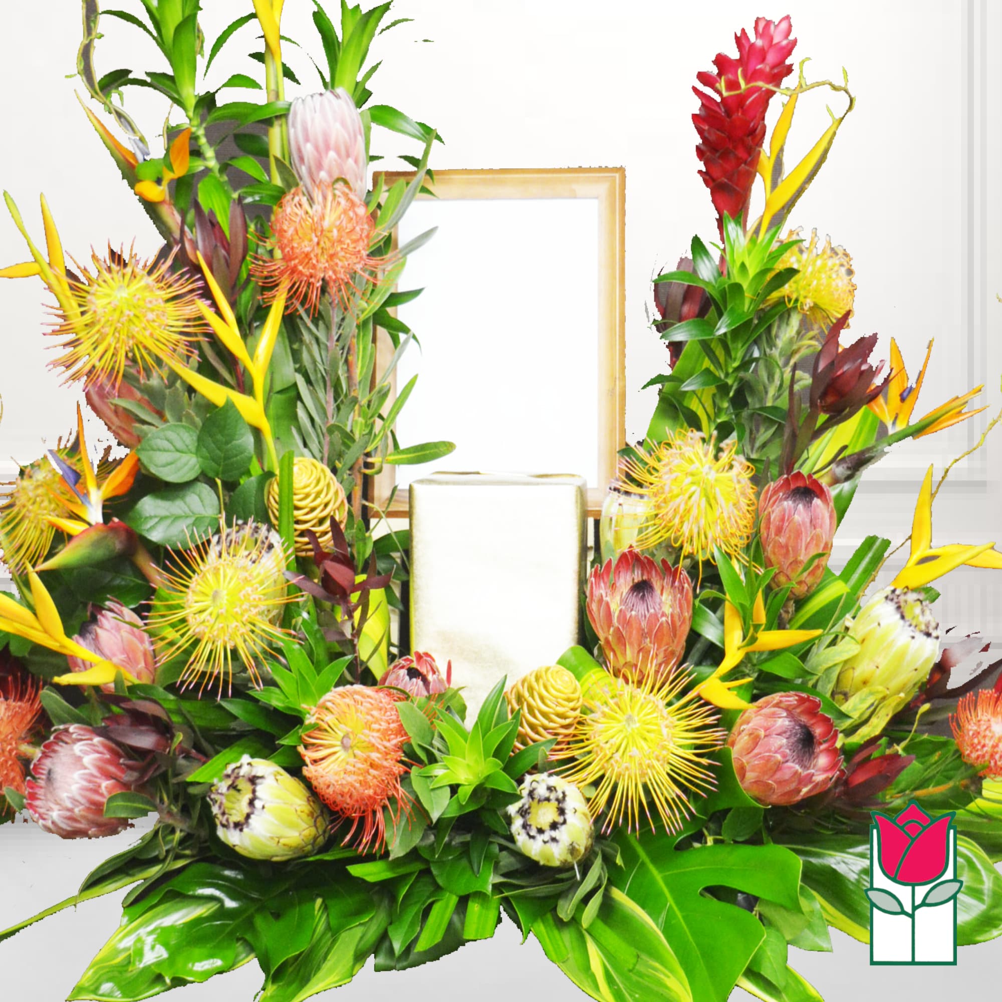 Tropical floral arrangement with protea and bird-of-paradise around candles