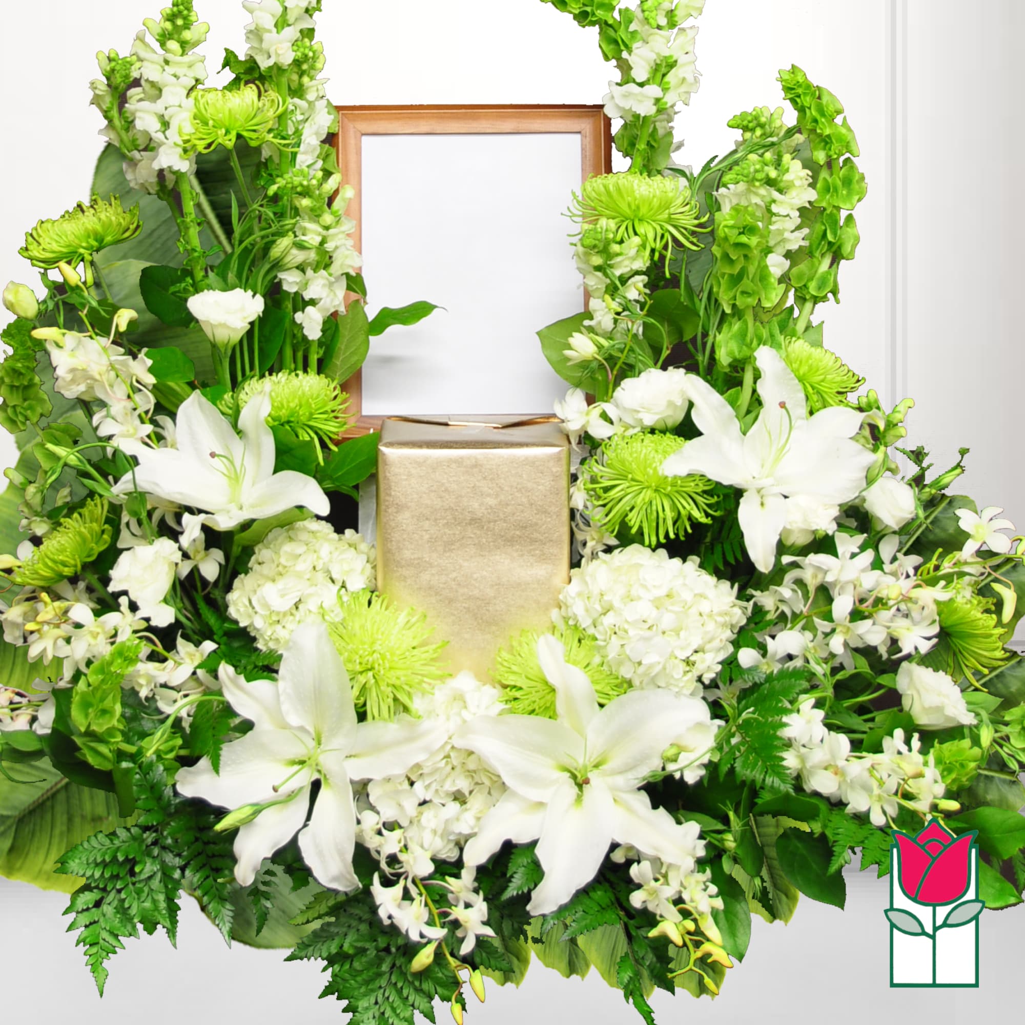 White lilies and green flowers arranged around a gold urn and frame, photo 2 of 2