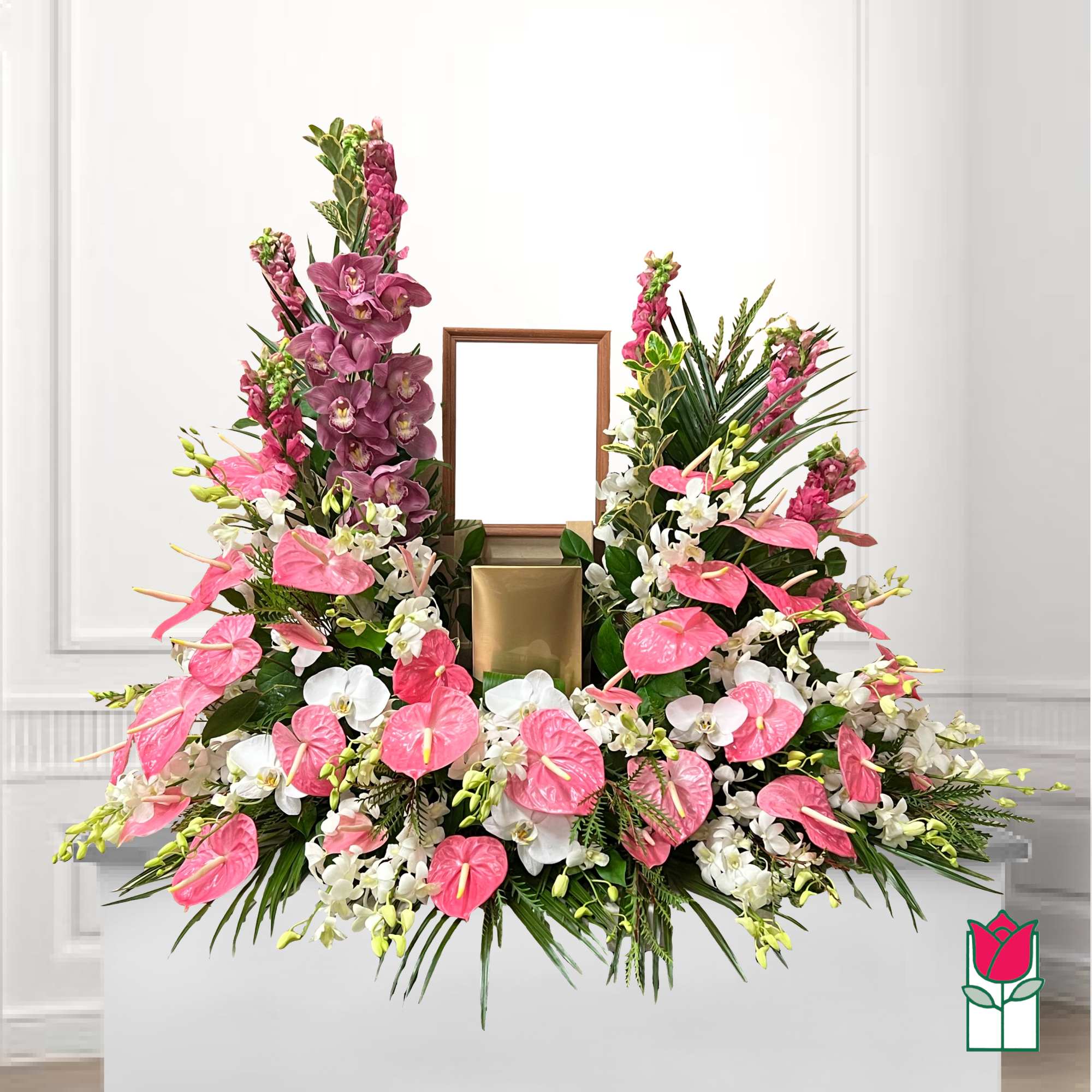 Pink and white floral arrangement with orchids and anthuriums around a frame