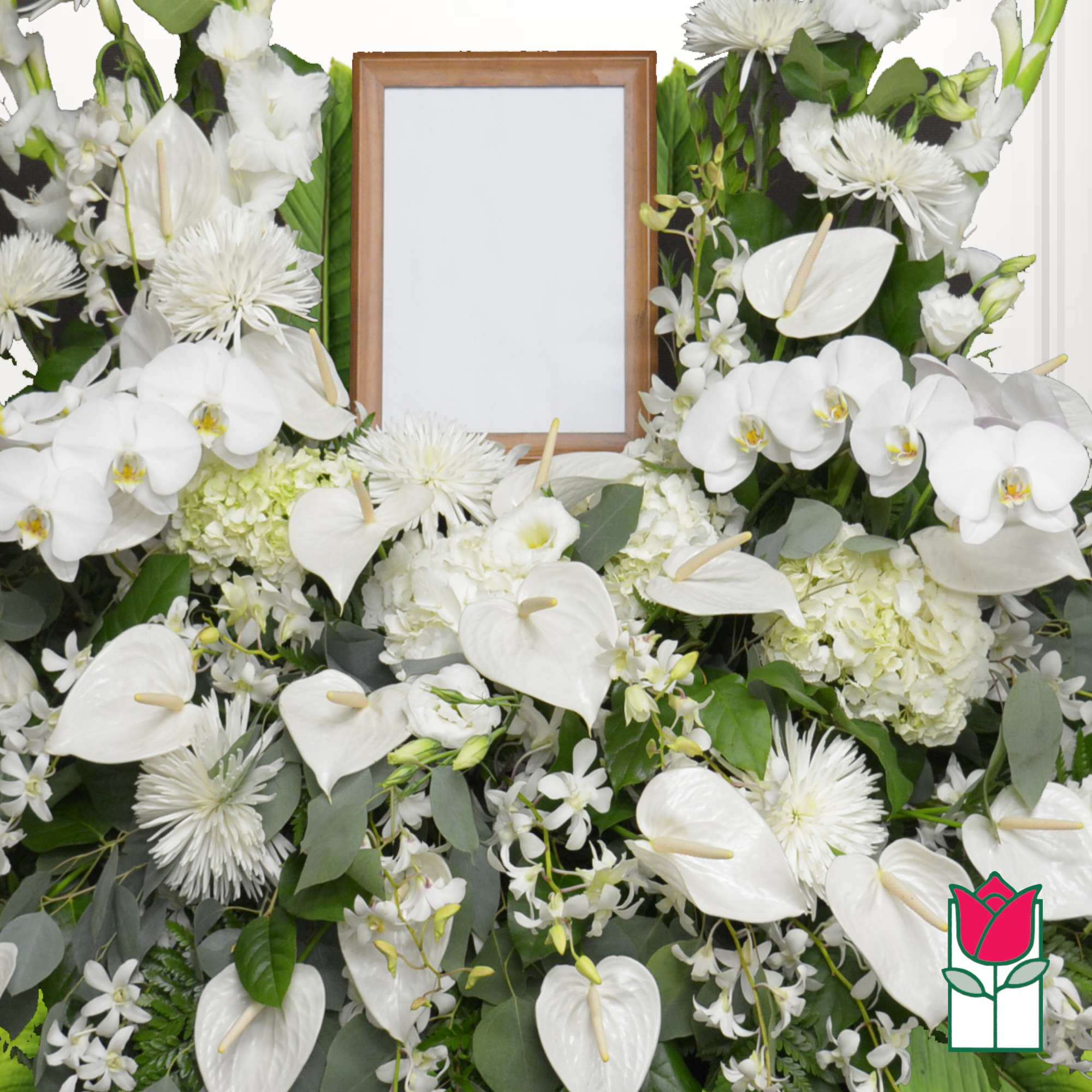 White floral funeral spray with a framed photo opening in the center