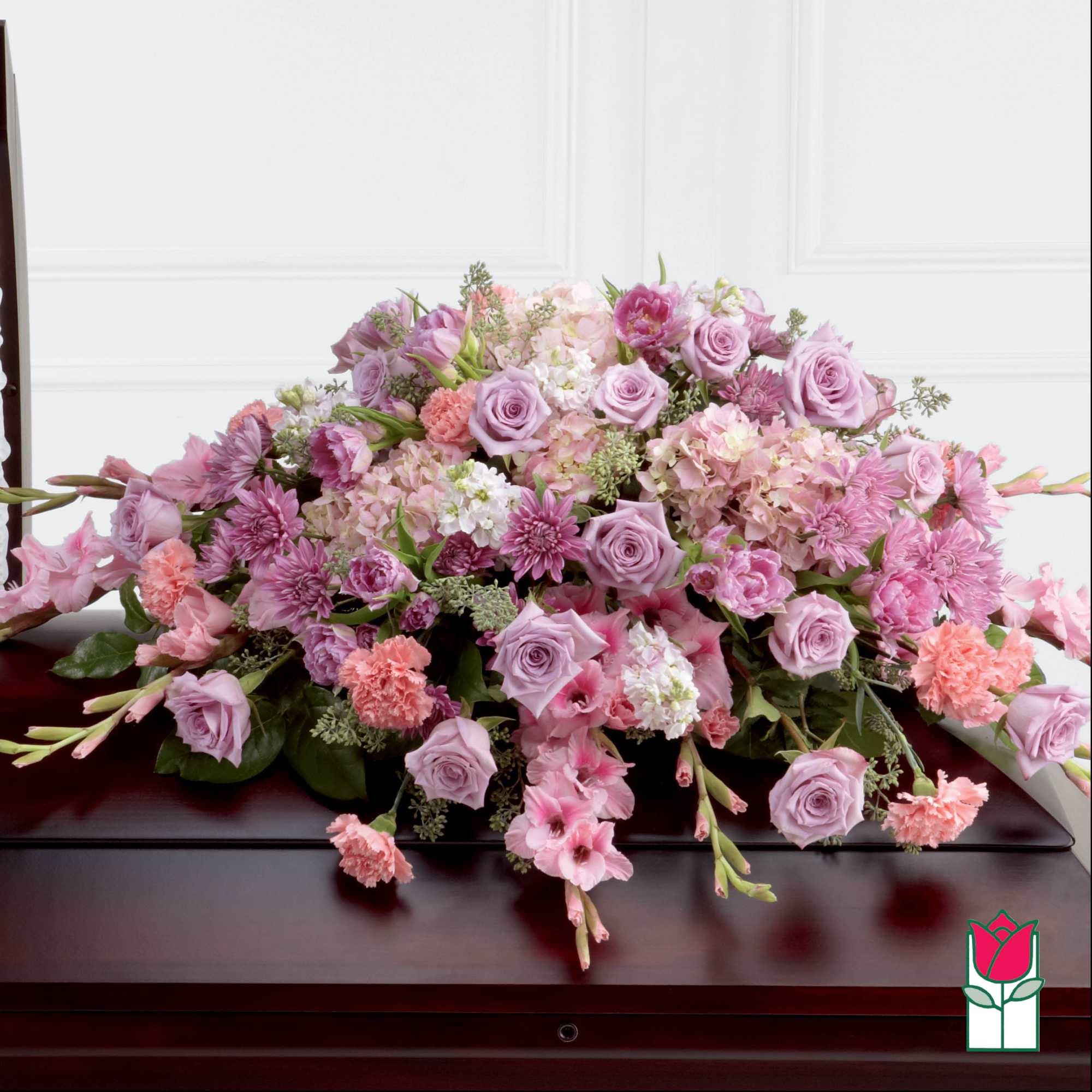 Large pink and lavender floral arrangement on a dark table