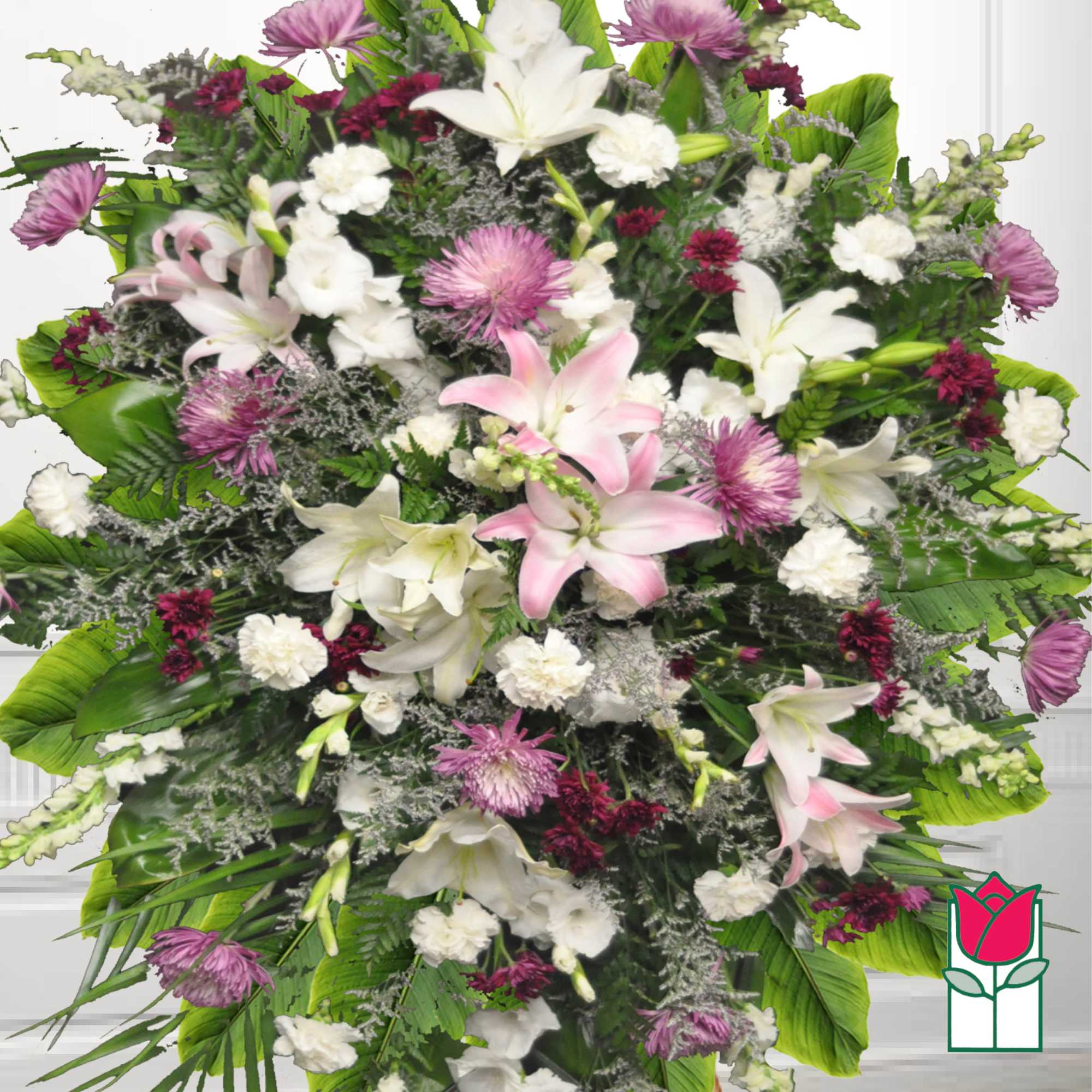 Large floral spray with white lilies, pink blooms, and purple accents