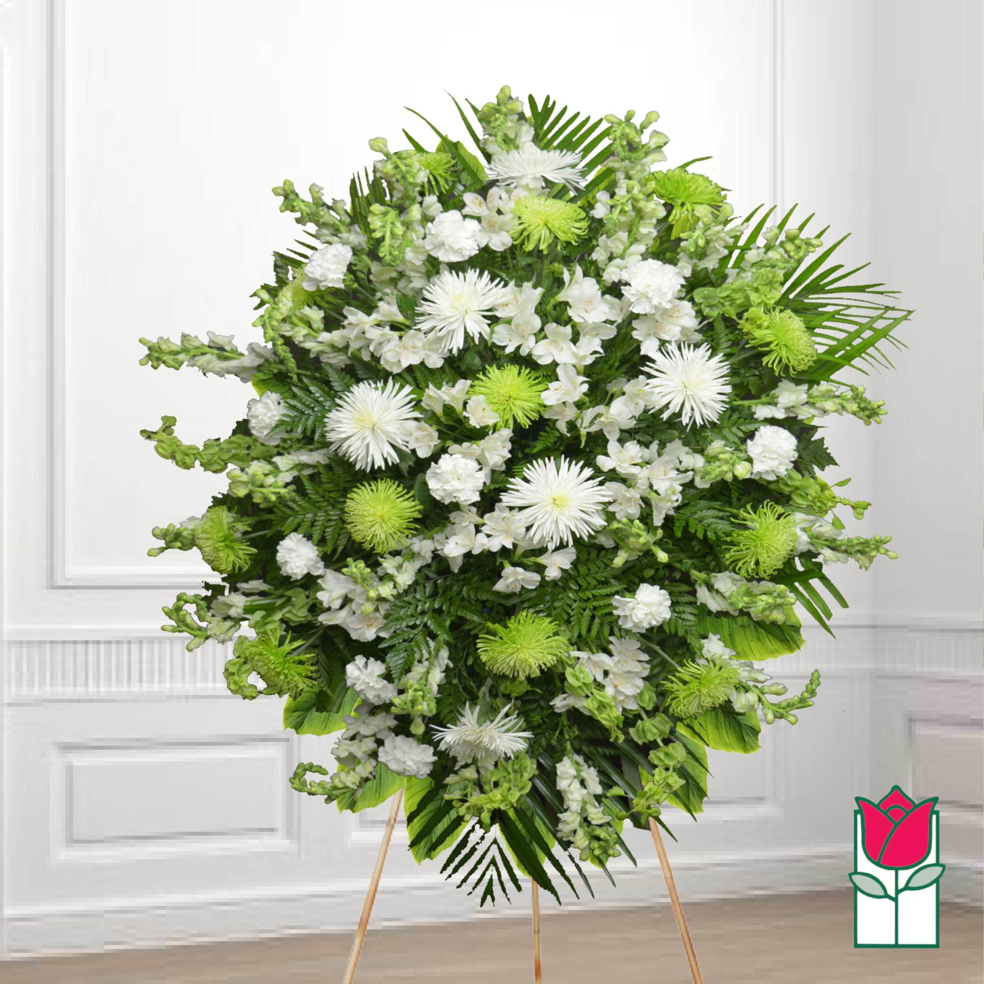 Large white and green funeral spray on a standing easel