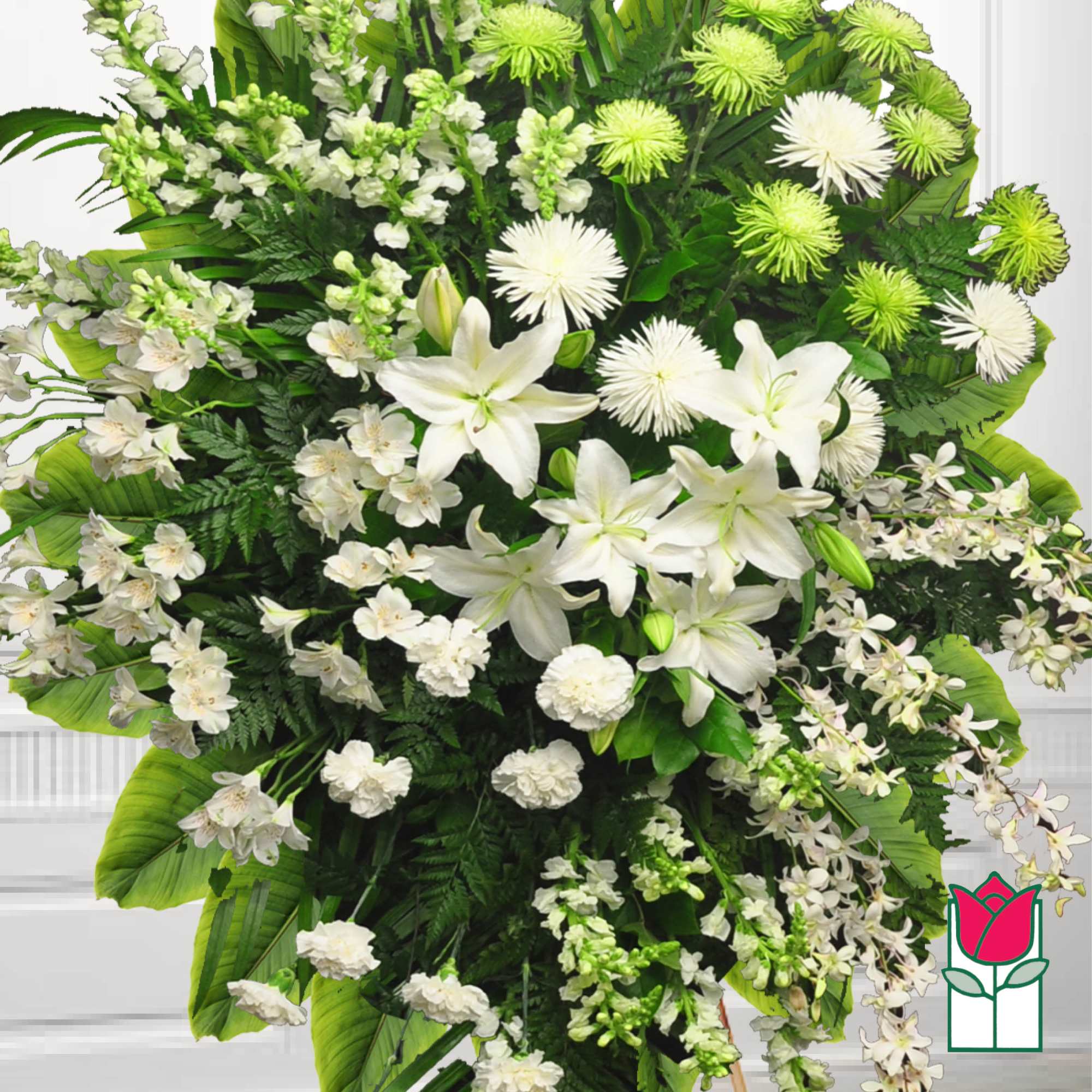 Large white funeral spray with lilies and green pom-pom flowers