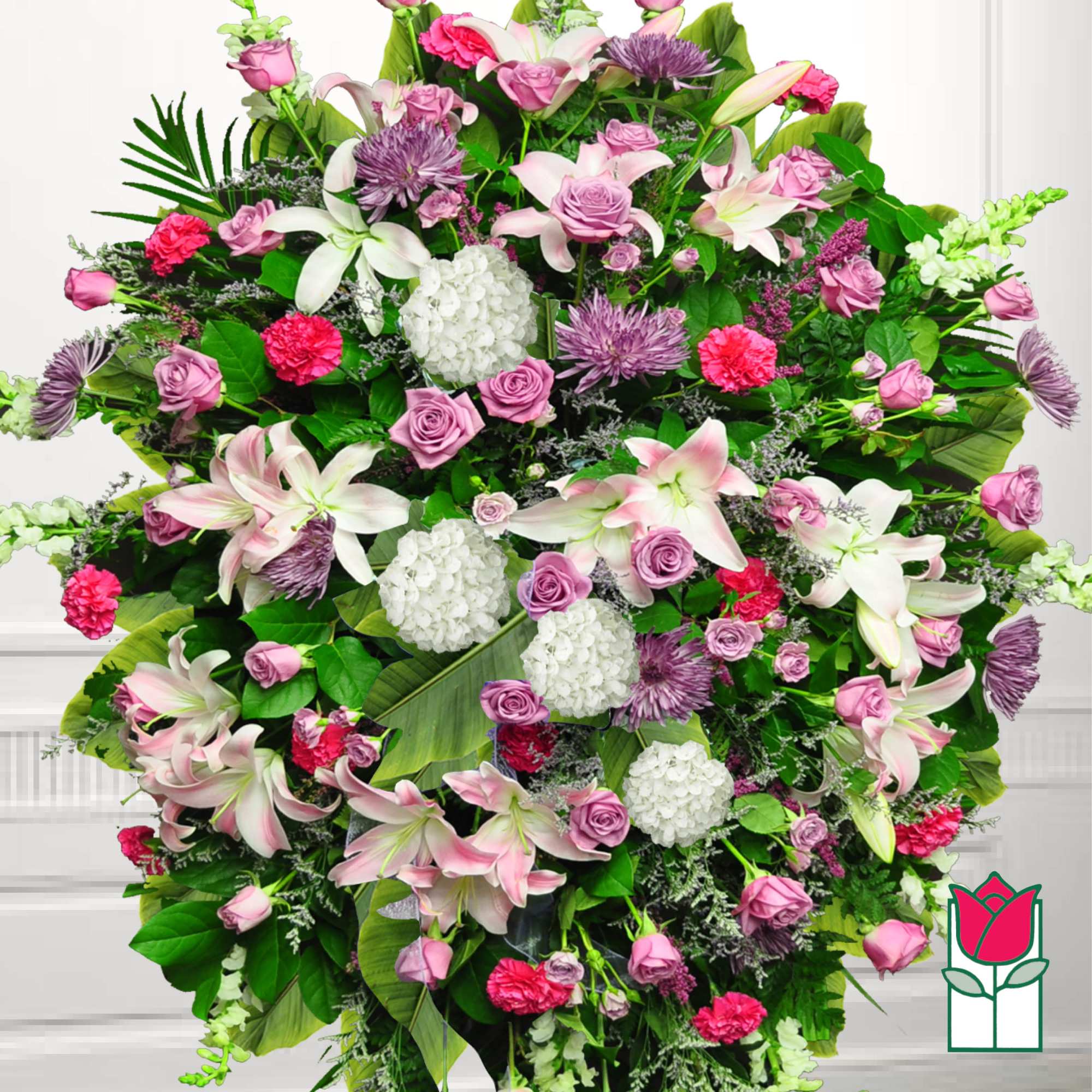 Large standing spray of pink and white flowers with lilies and roses