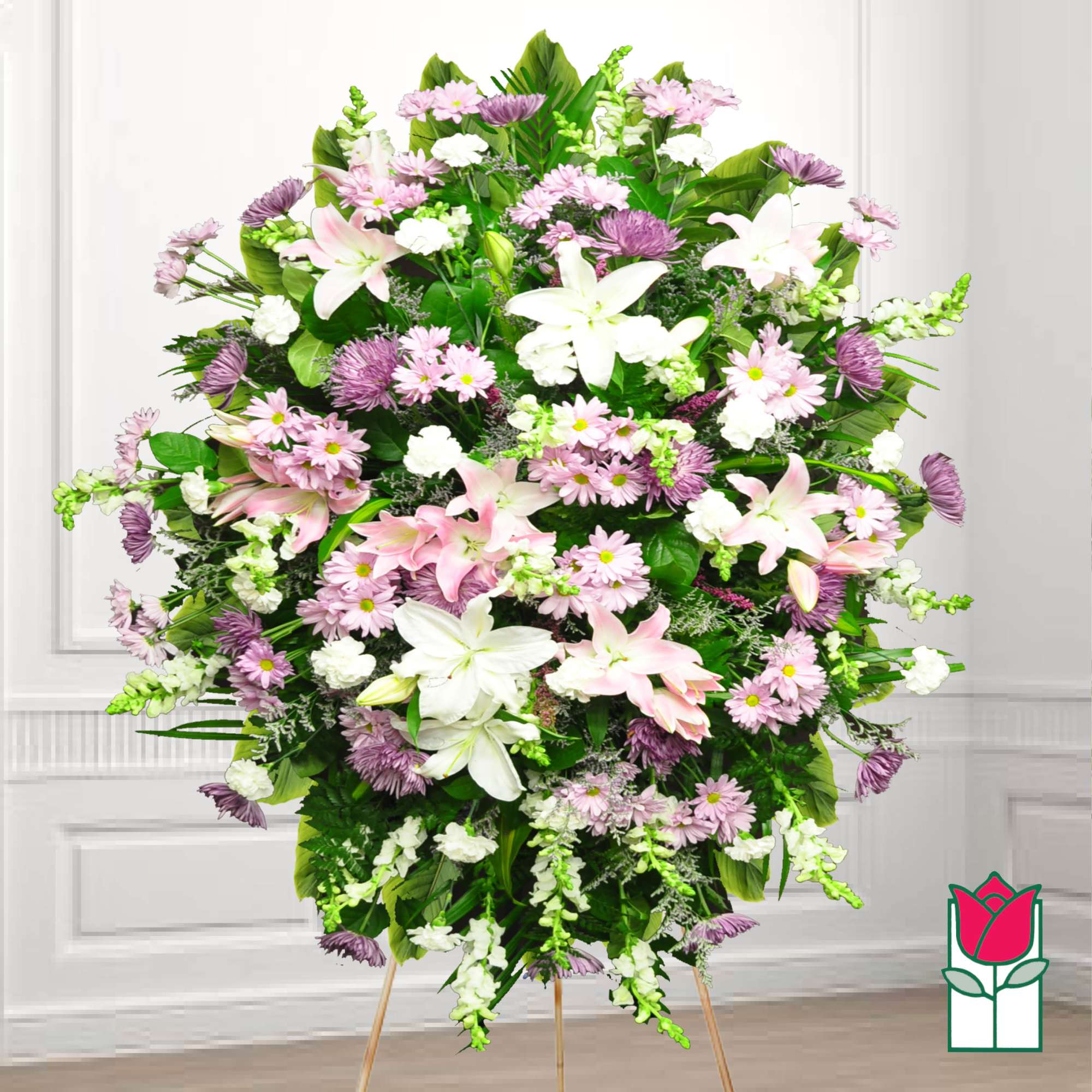 Large standing spray of pink and white flowers on a wooden easel