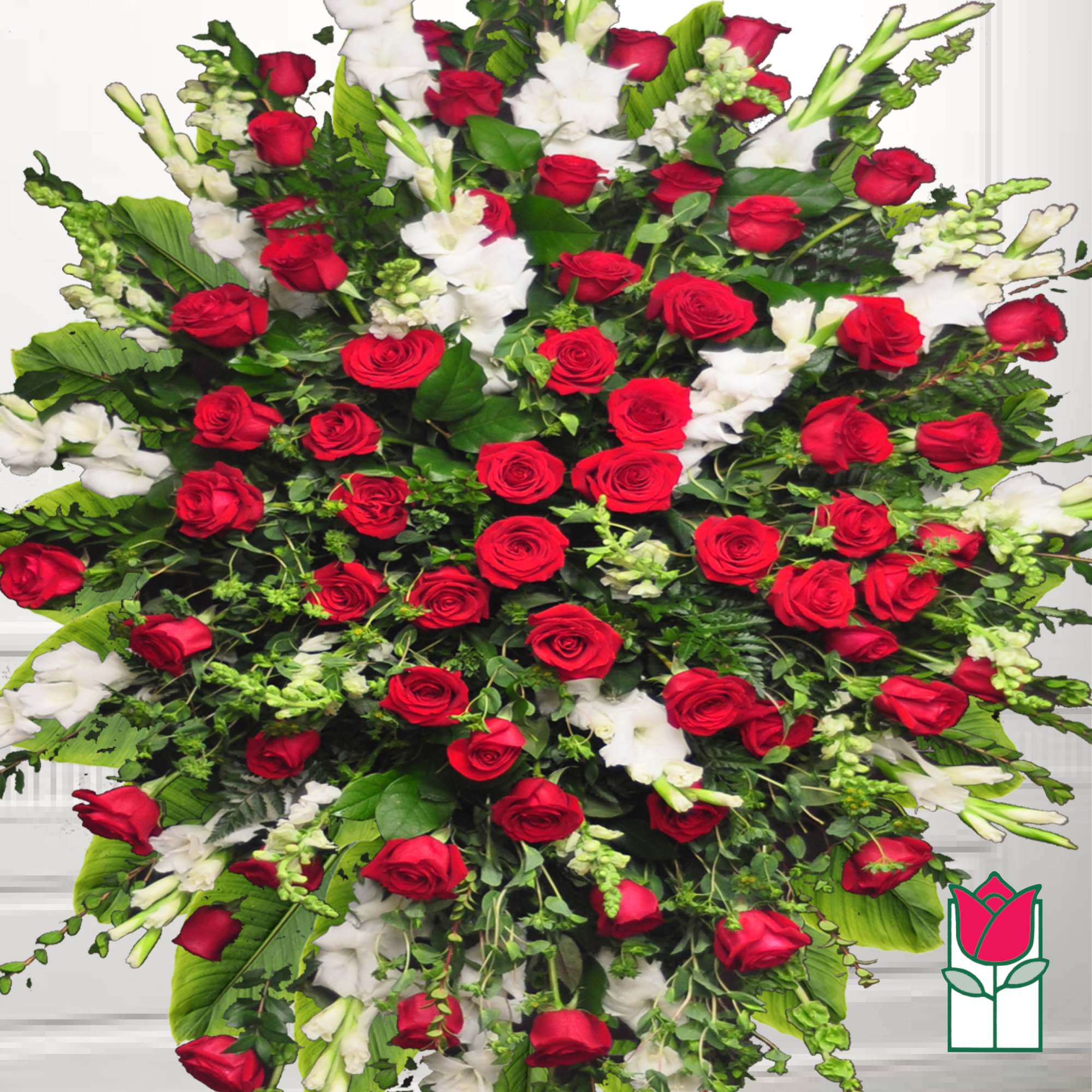 Large red and white rose arrangement with mixed greenery