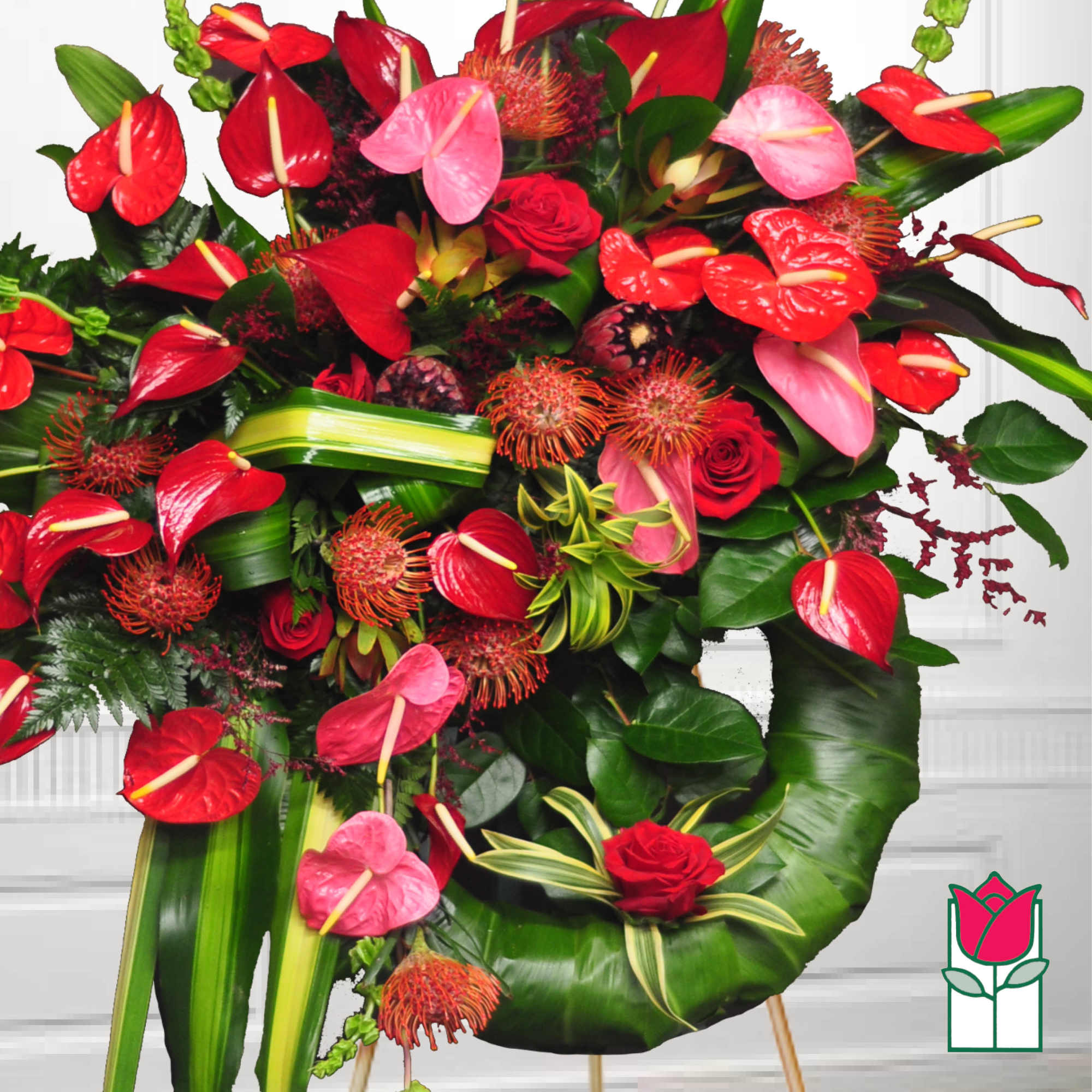 Tropical bouquet with red and pink anthuriums and roses