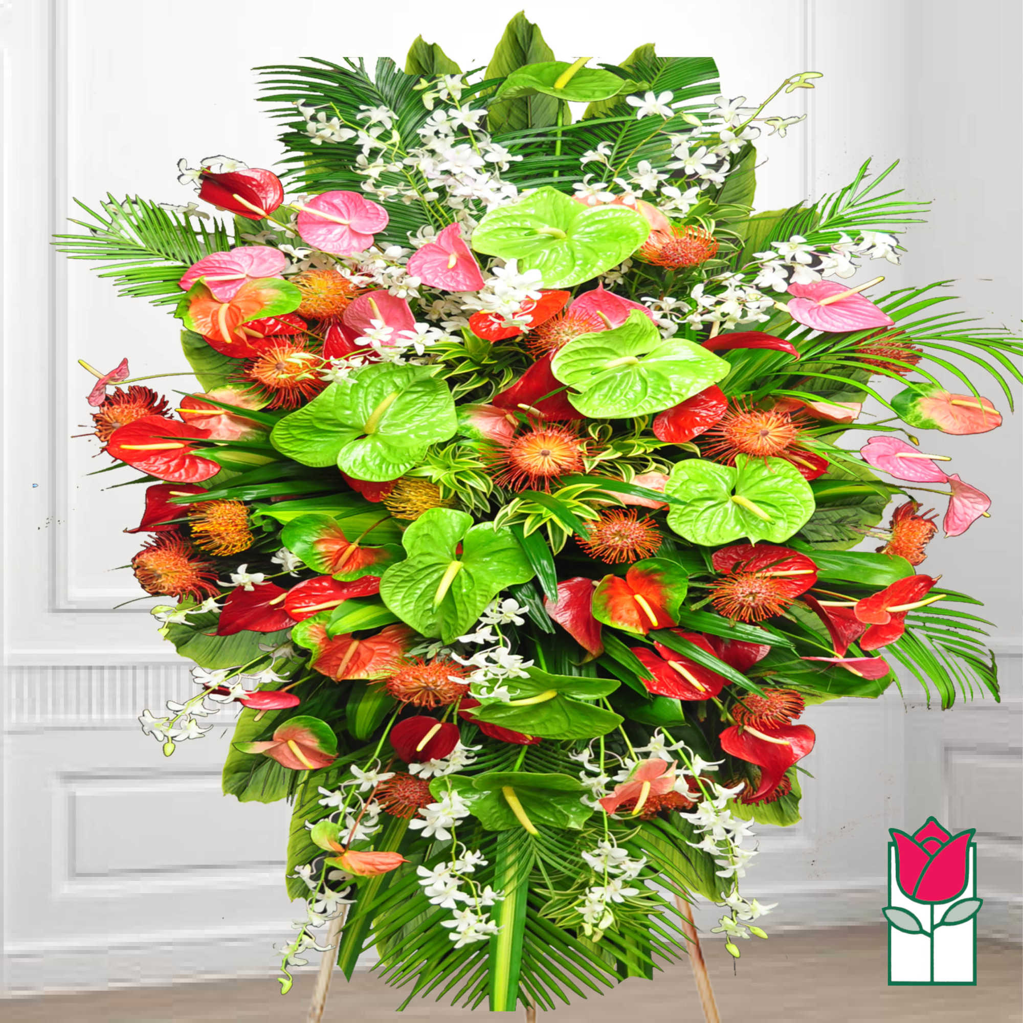 Large tropical standing arrangement with red, pink, and green anthuriums