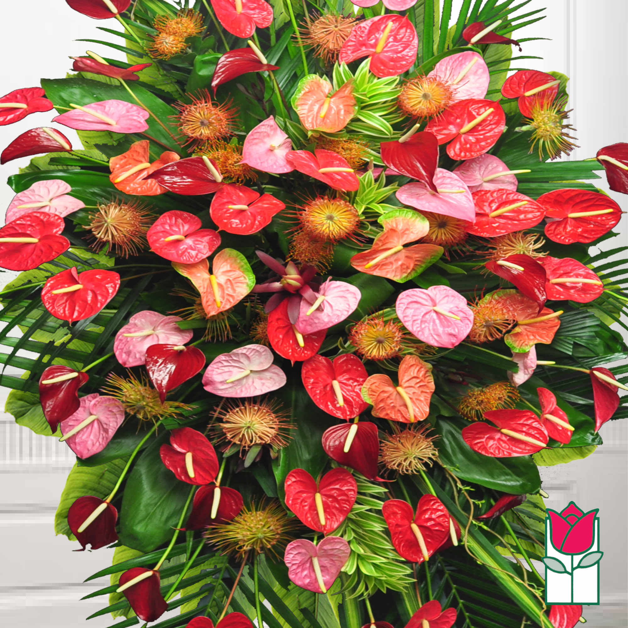 Large tropical arrangement with red and pink anthuriums