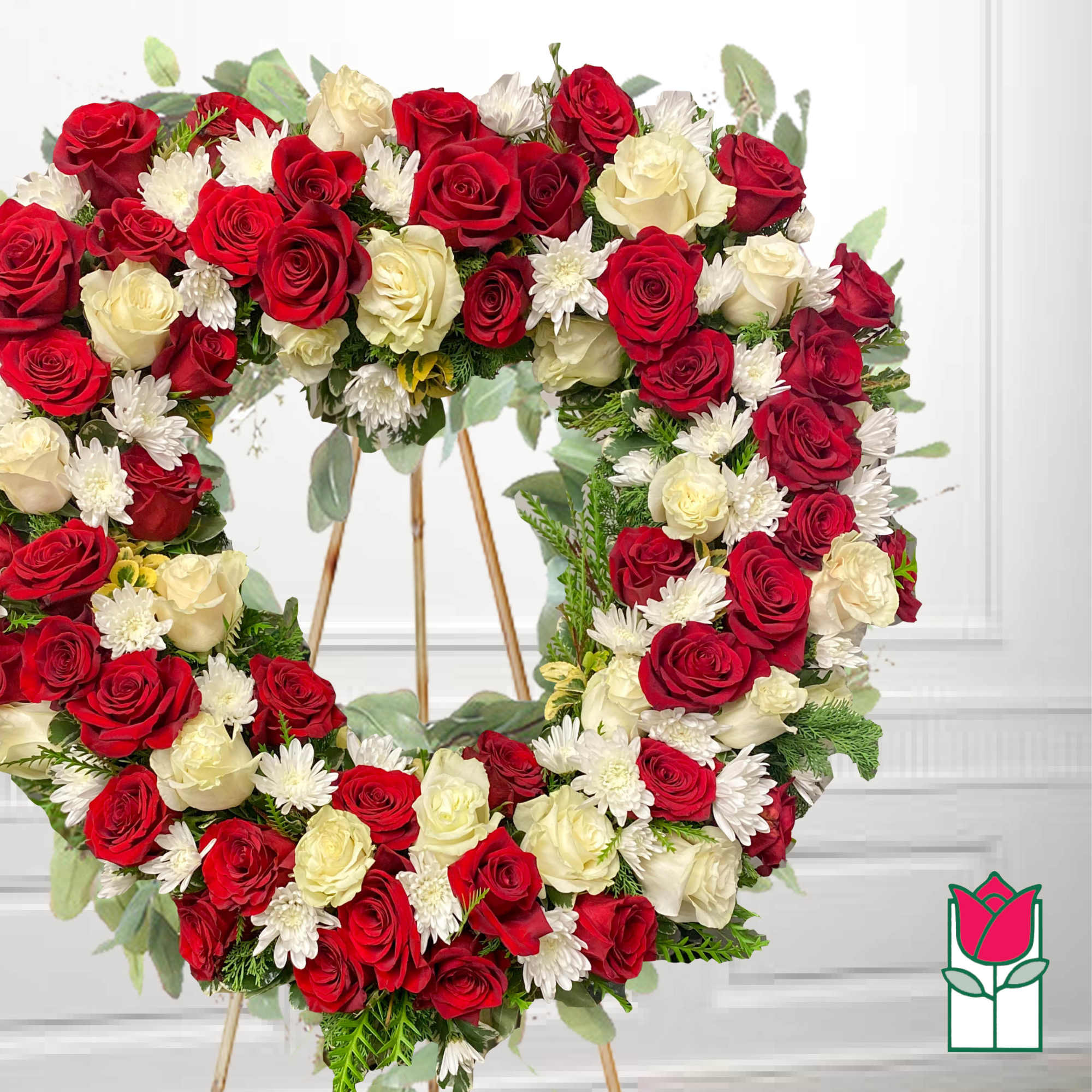 Circular wreath of red and white roses with white daisies