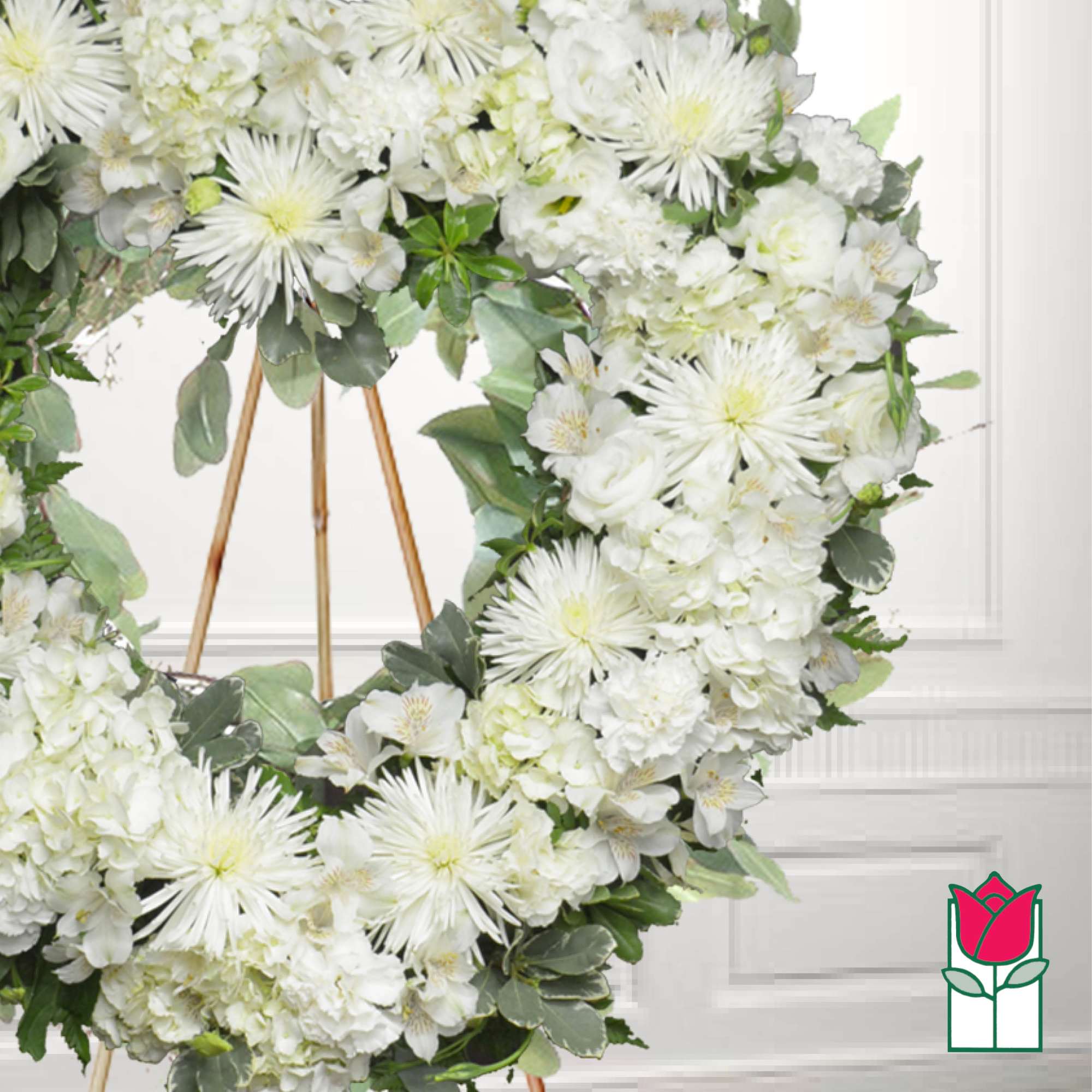 White floral wreath on a wooden stand