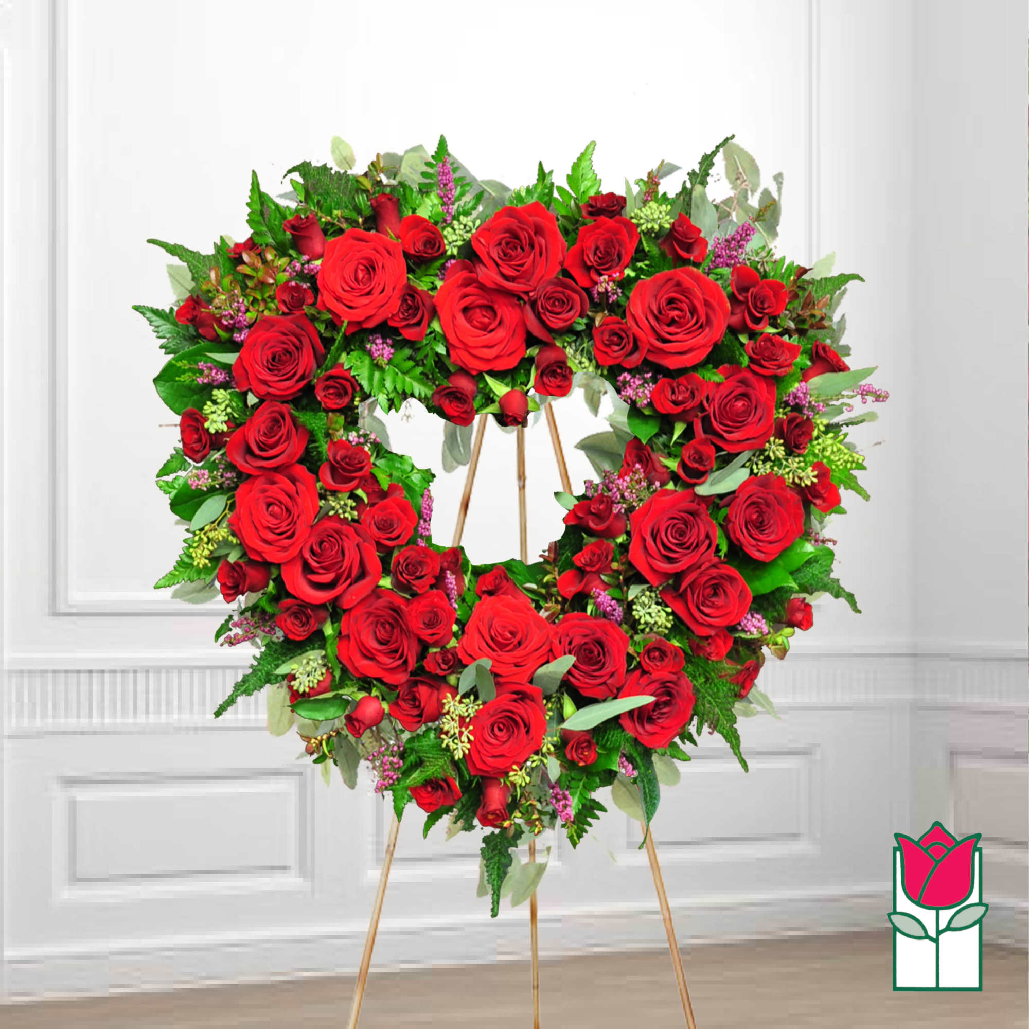 Heart-shaped wreath of red roses on a standing easel