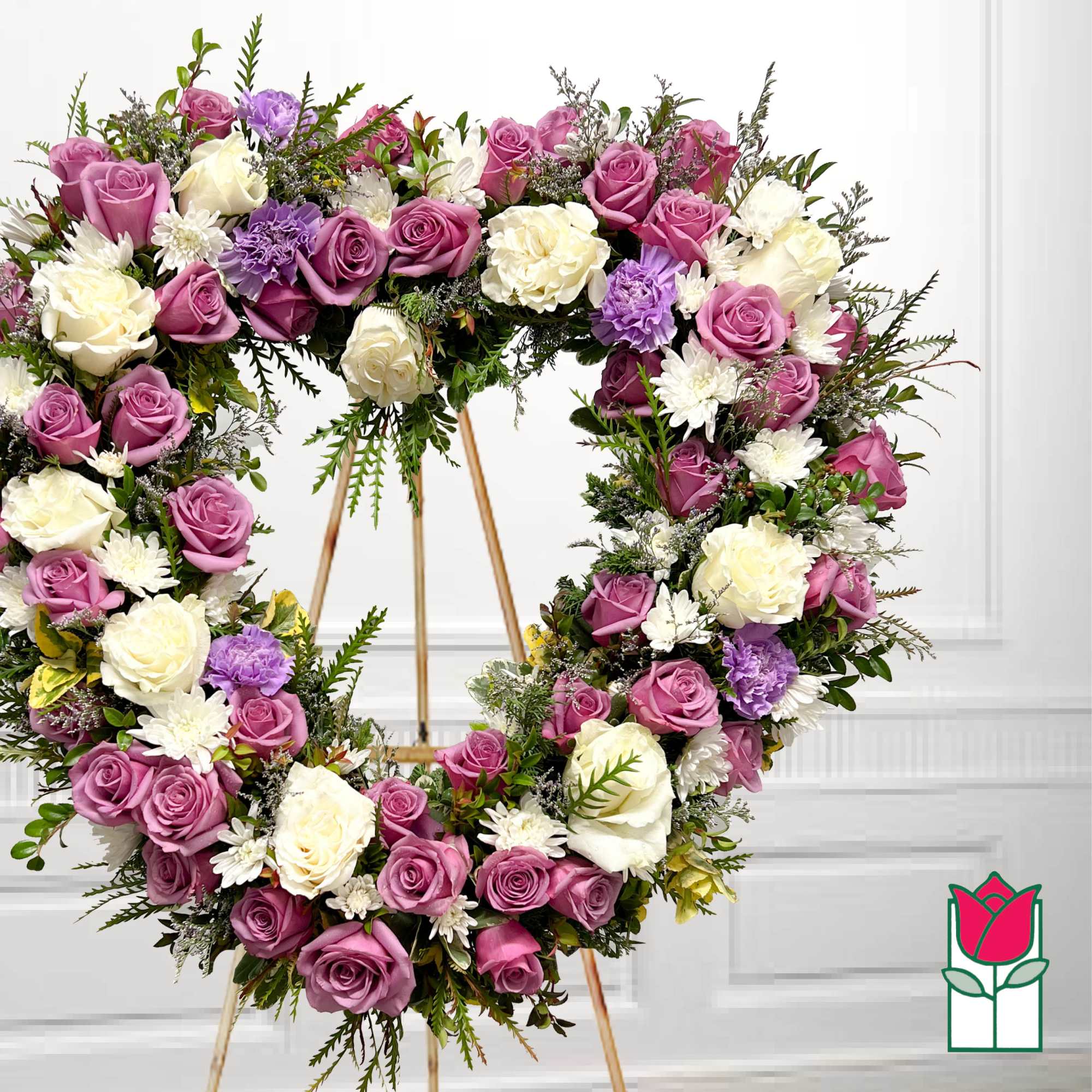 Heart-shaped floral wreath with pink, white, and lavender roses