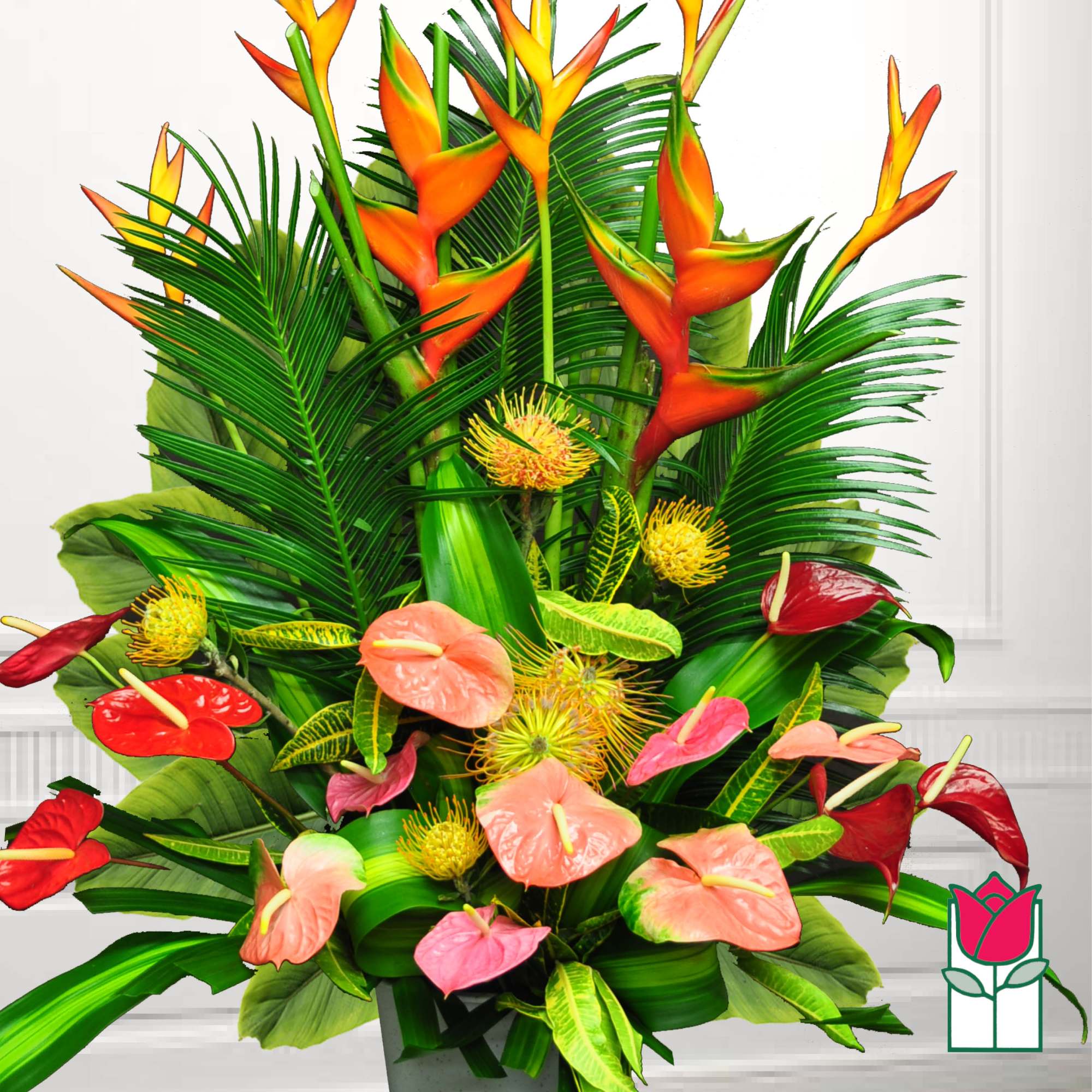 Tropical arrangement with orange heliconia and pink anthuriums in a vase